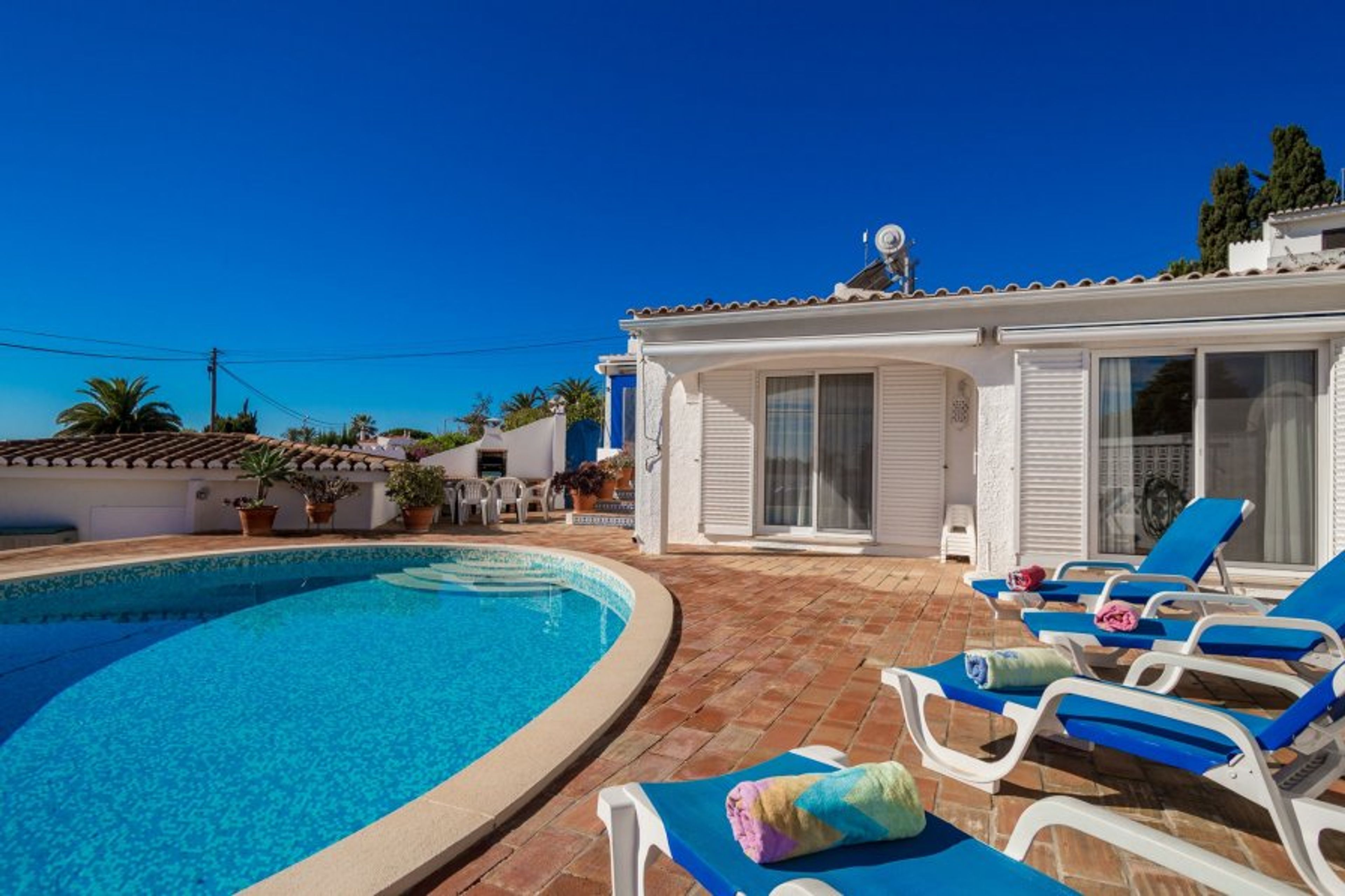 Pool area with BBQ in background