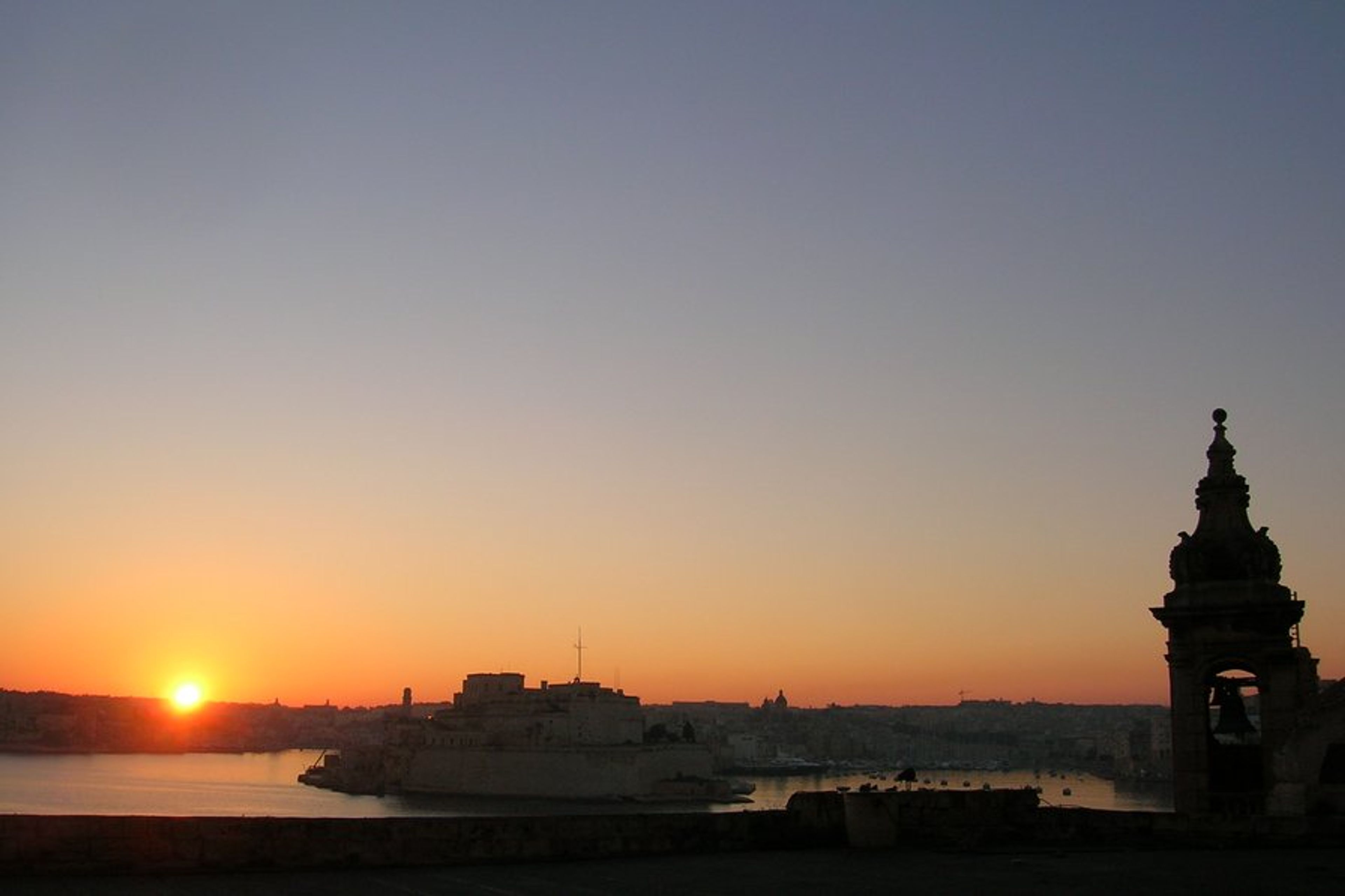 Sunrise over Fort Angelo and the Three Cities from our balcony
