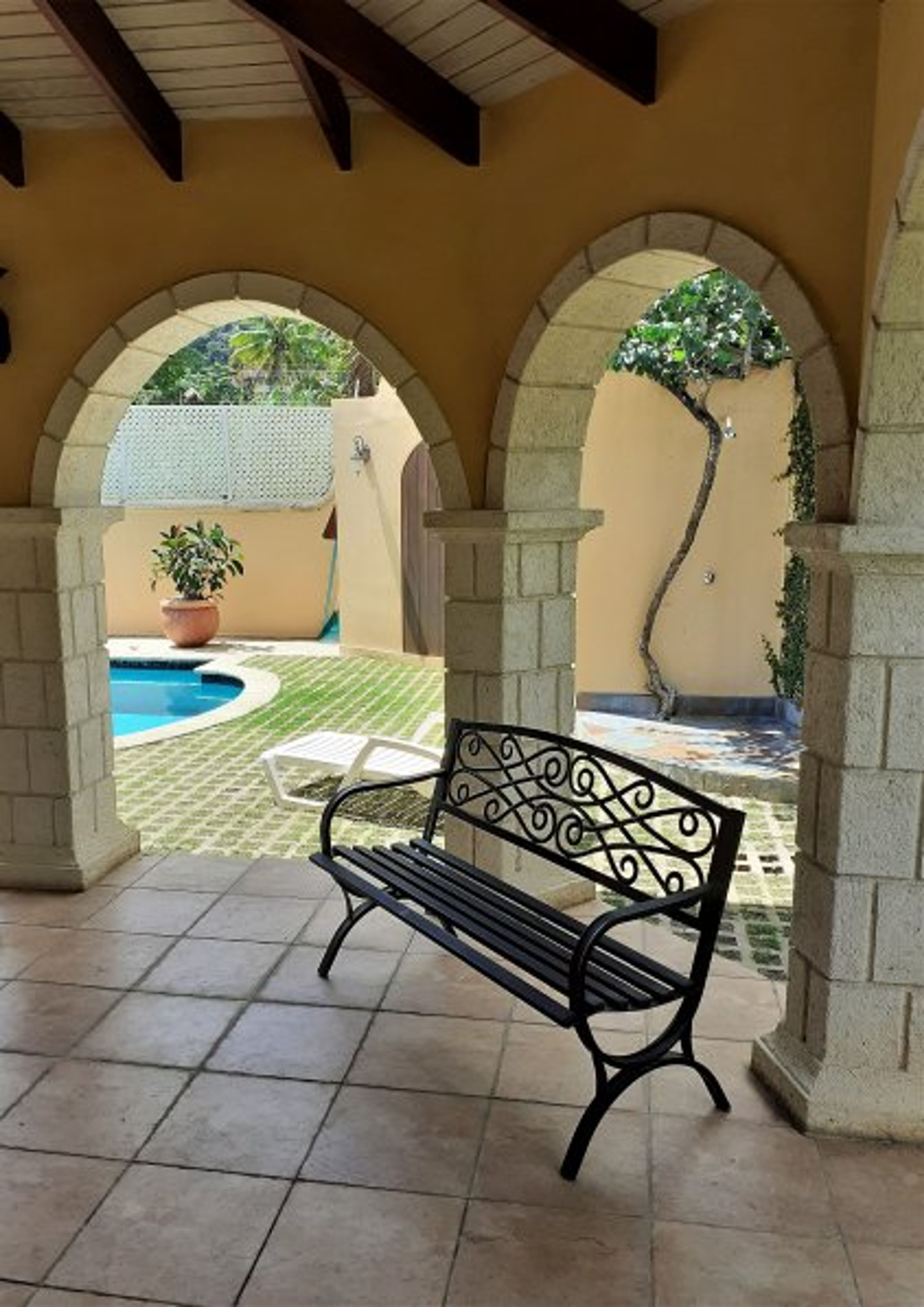 Back porch of main house with shared pool and outdoor shower/toilet