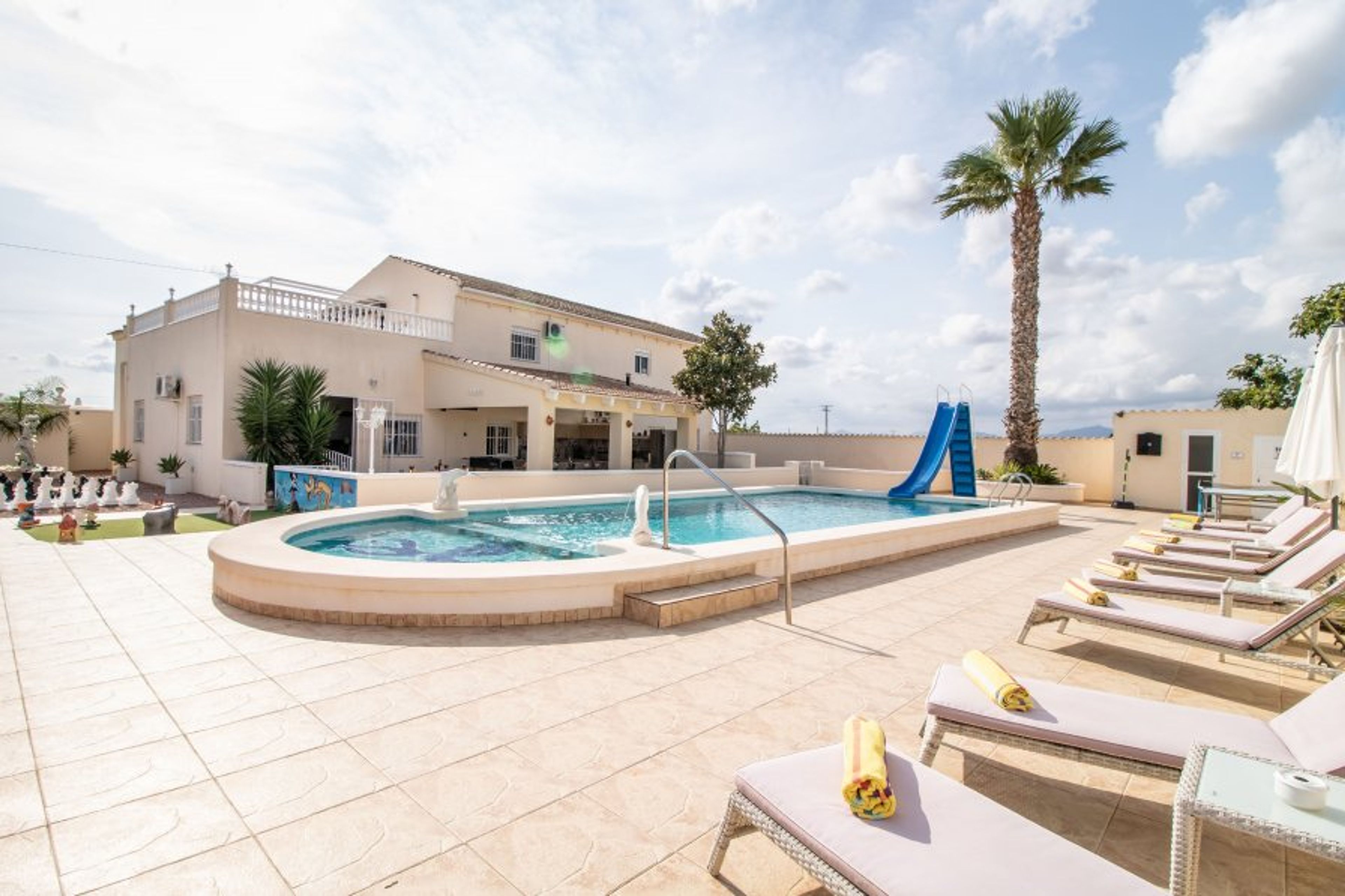 View of Swimming pool with Slide, Outside shower with toilet. 