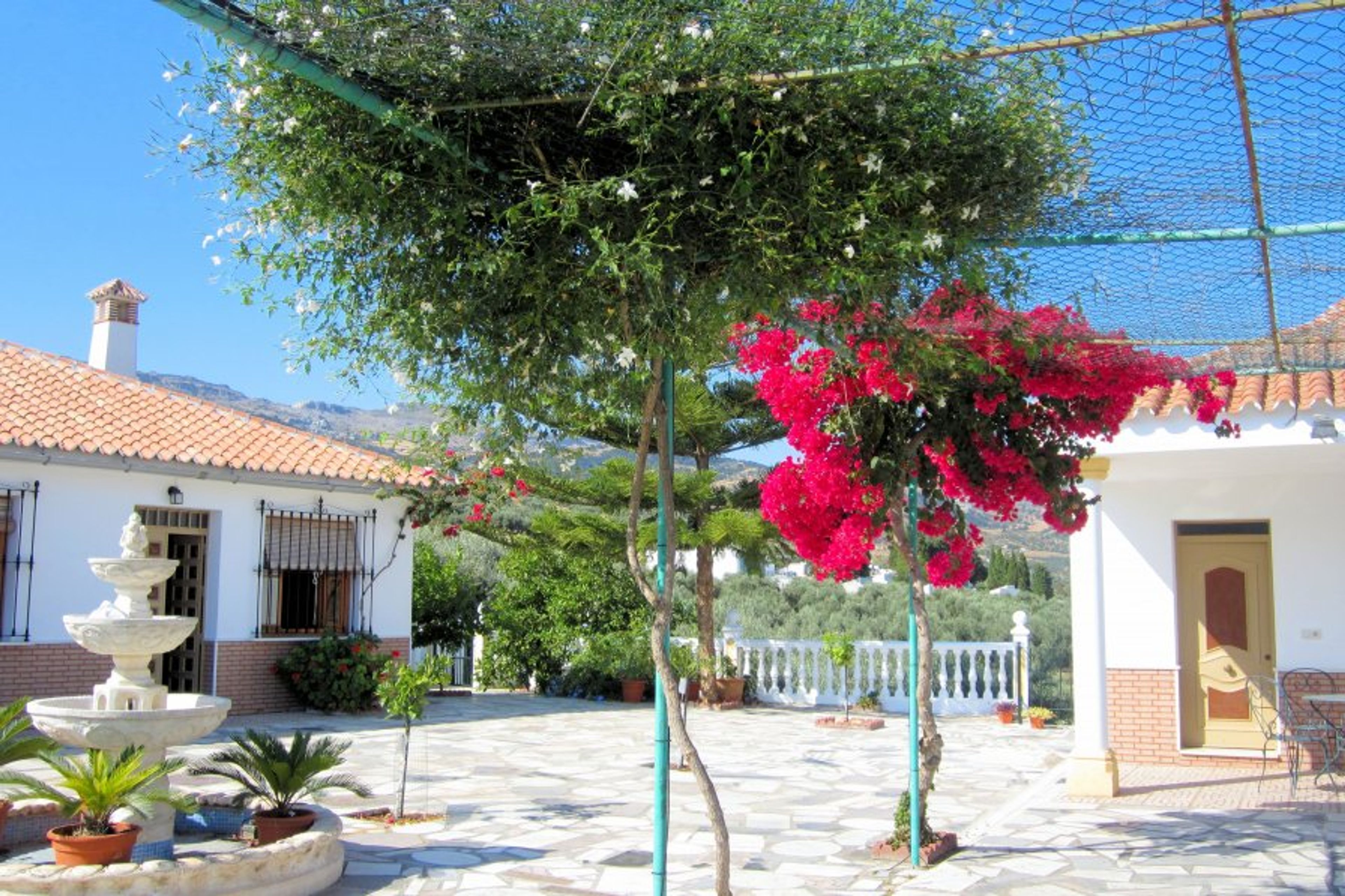 Main terrace with the house left, and the store house on the right. 
