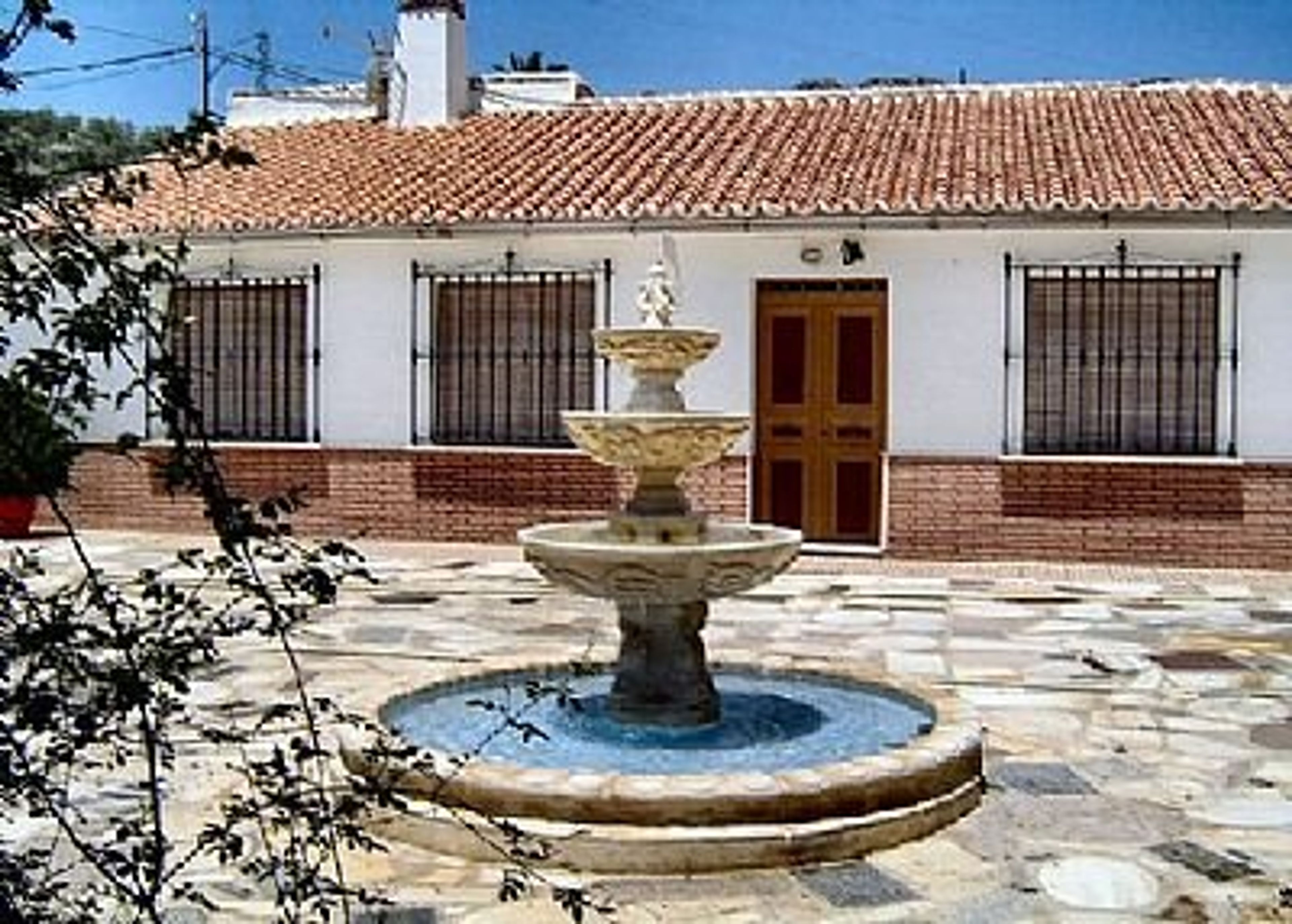 Front of the house with fountain in background