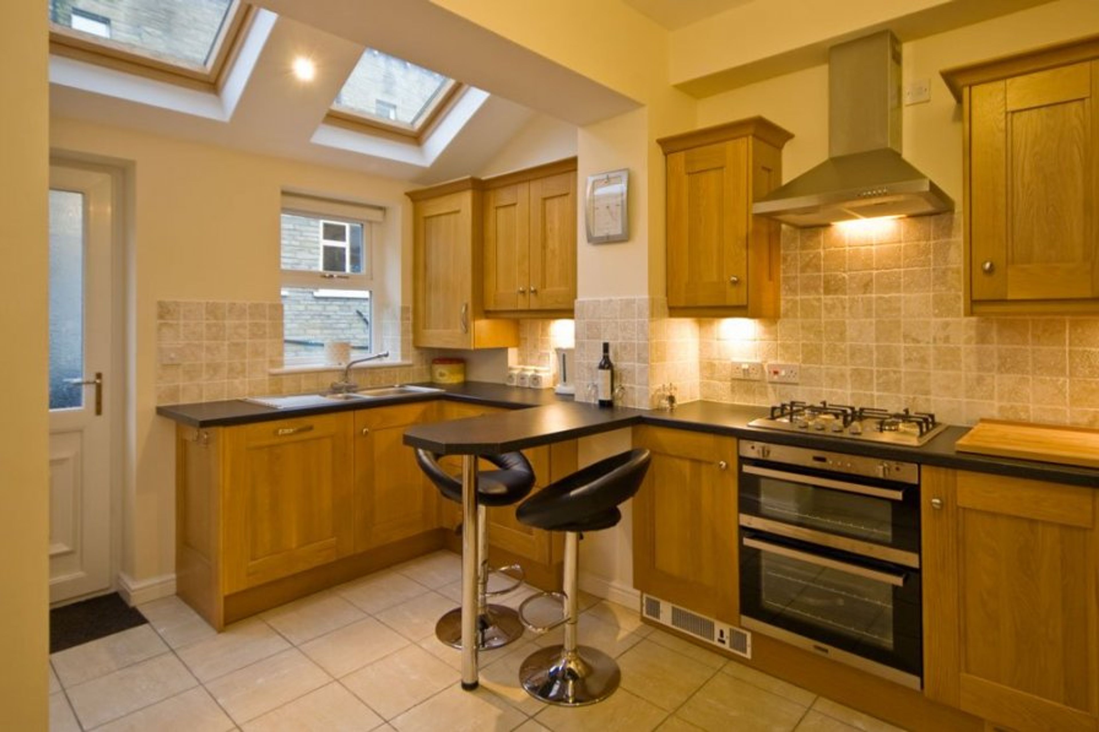 Fully appointed modern kitchen with skylights breakfast bar. 

