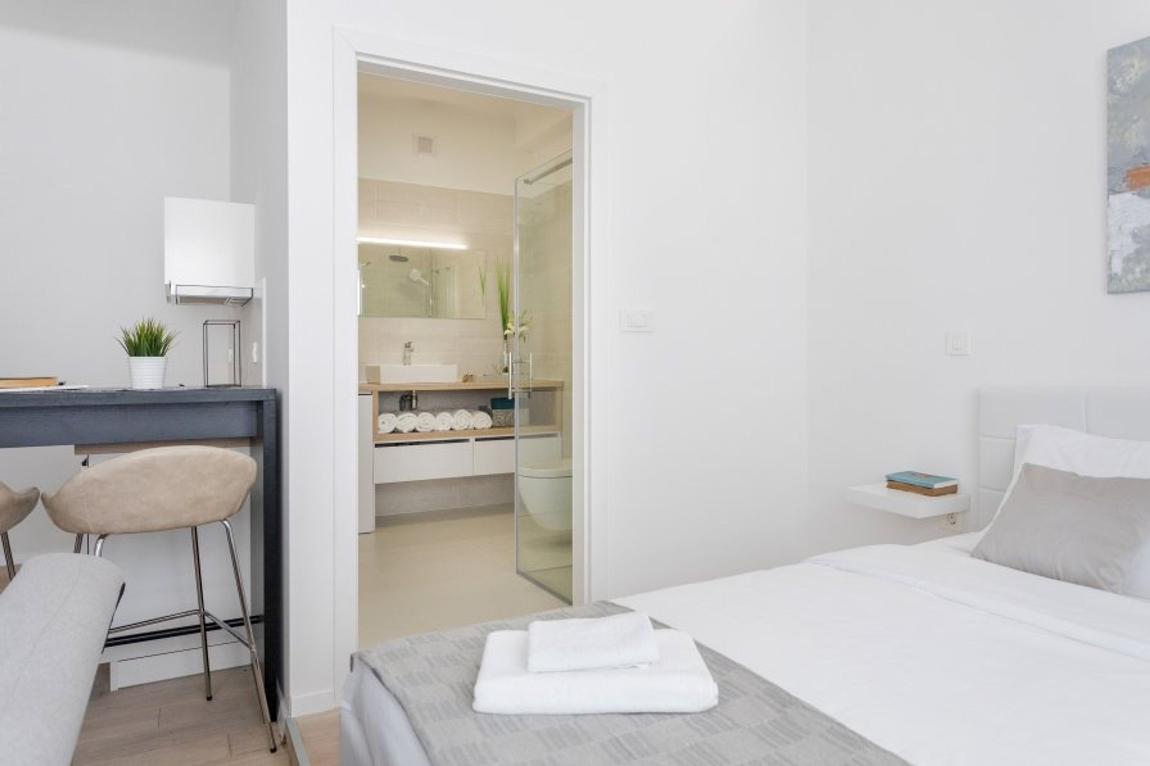 A modern bathroom with a spacious walk-in shower in every studio apartment!