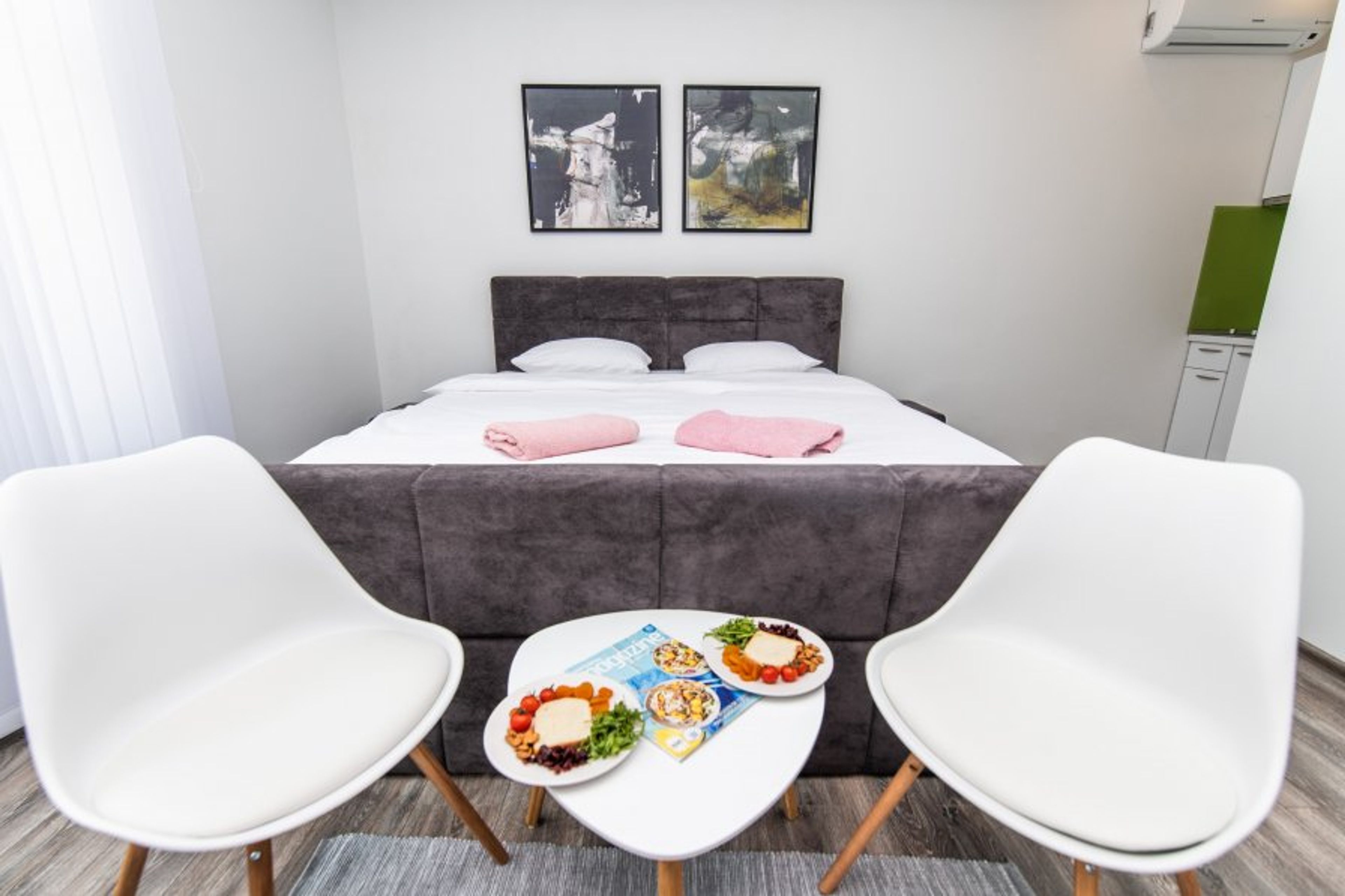 A king size bed with a seating/dining area