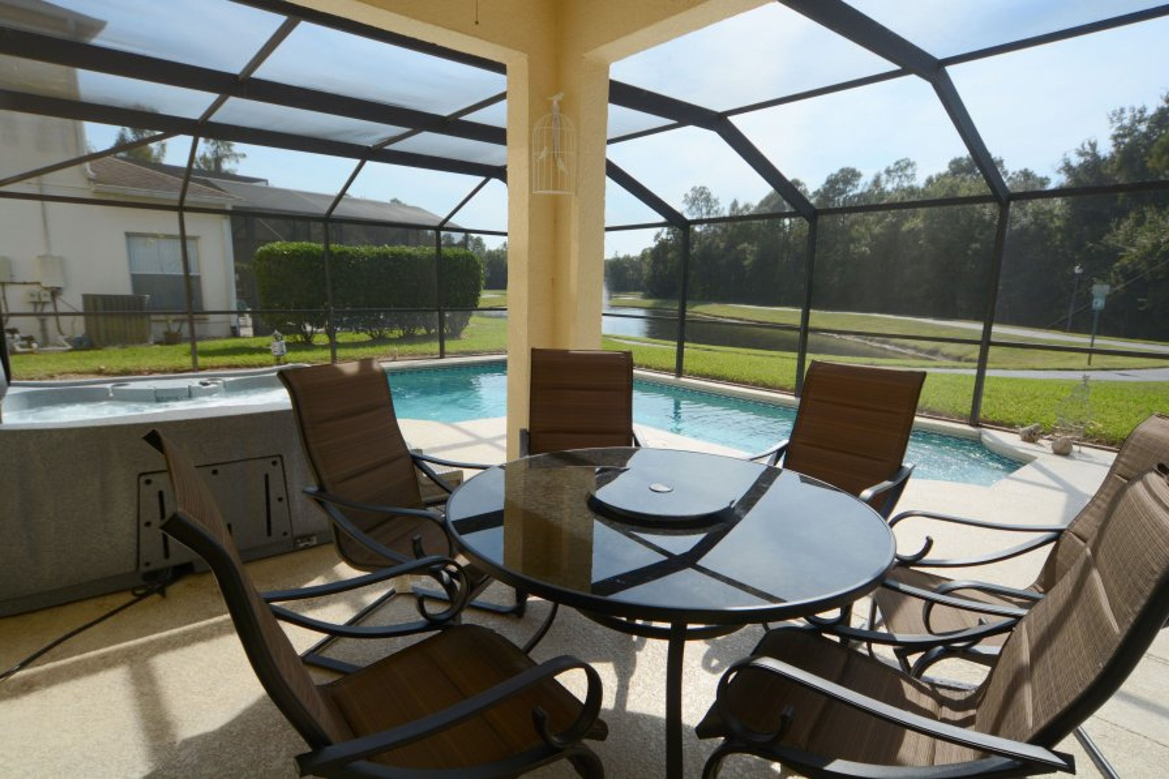 Family dining table with pool and lake view