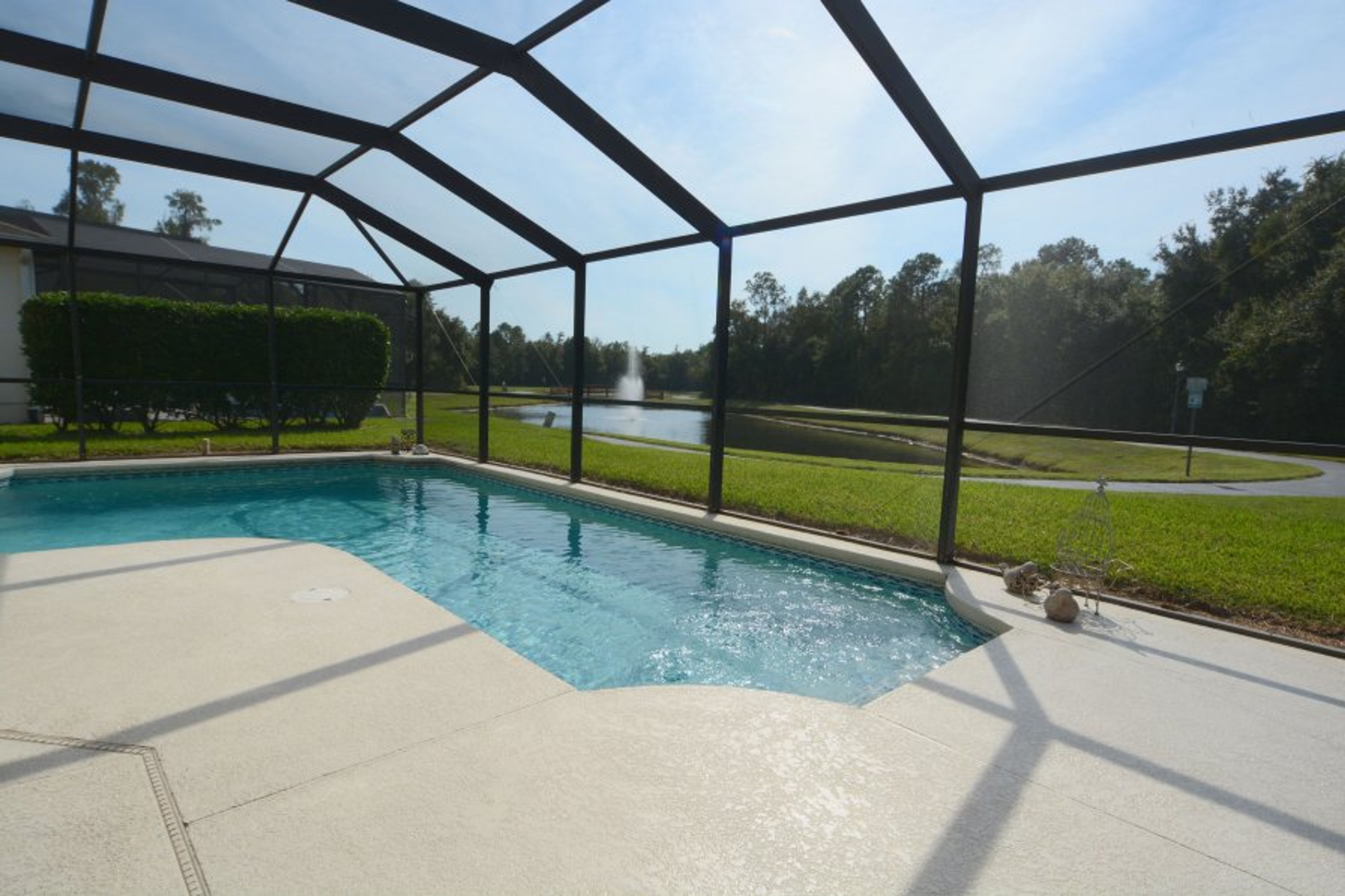 Private swimming pool with sun beds and lake view