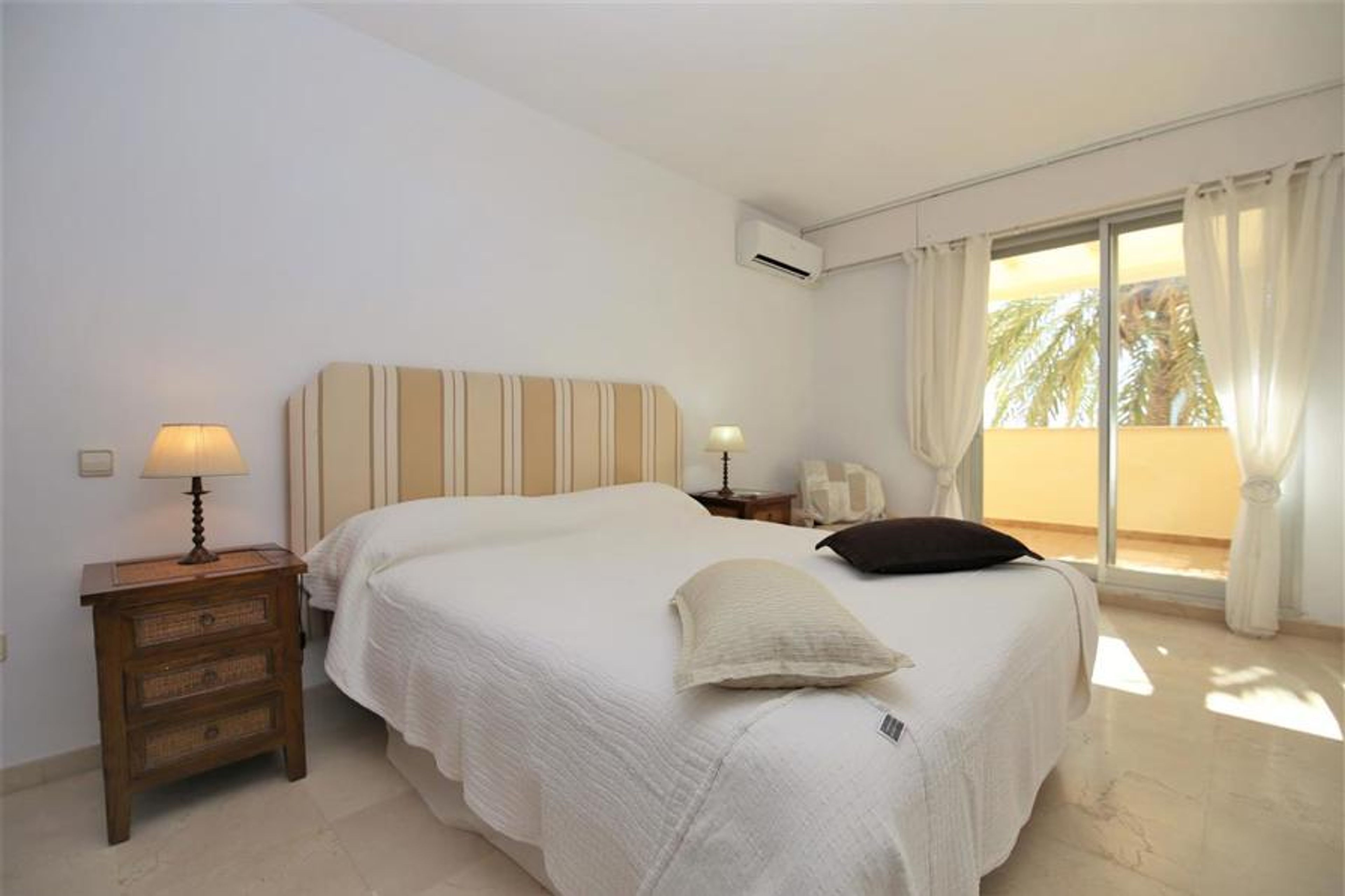 Bright master bedroom with king size bed and air c