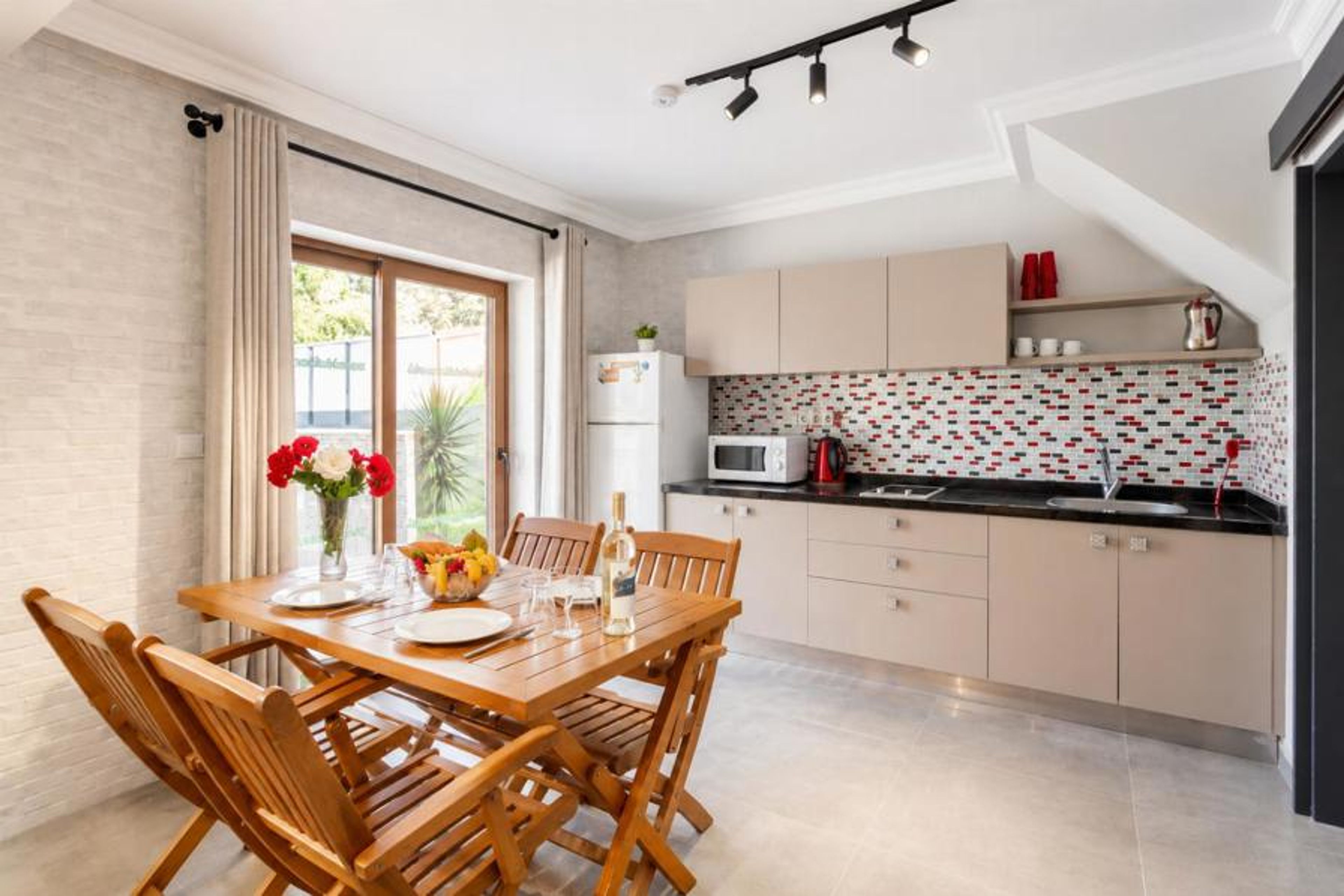 Open-plan living room with sofa, dining area, kitchen, A/C, WiFi internet, satellite TV, and terrace access