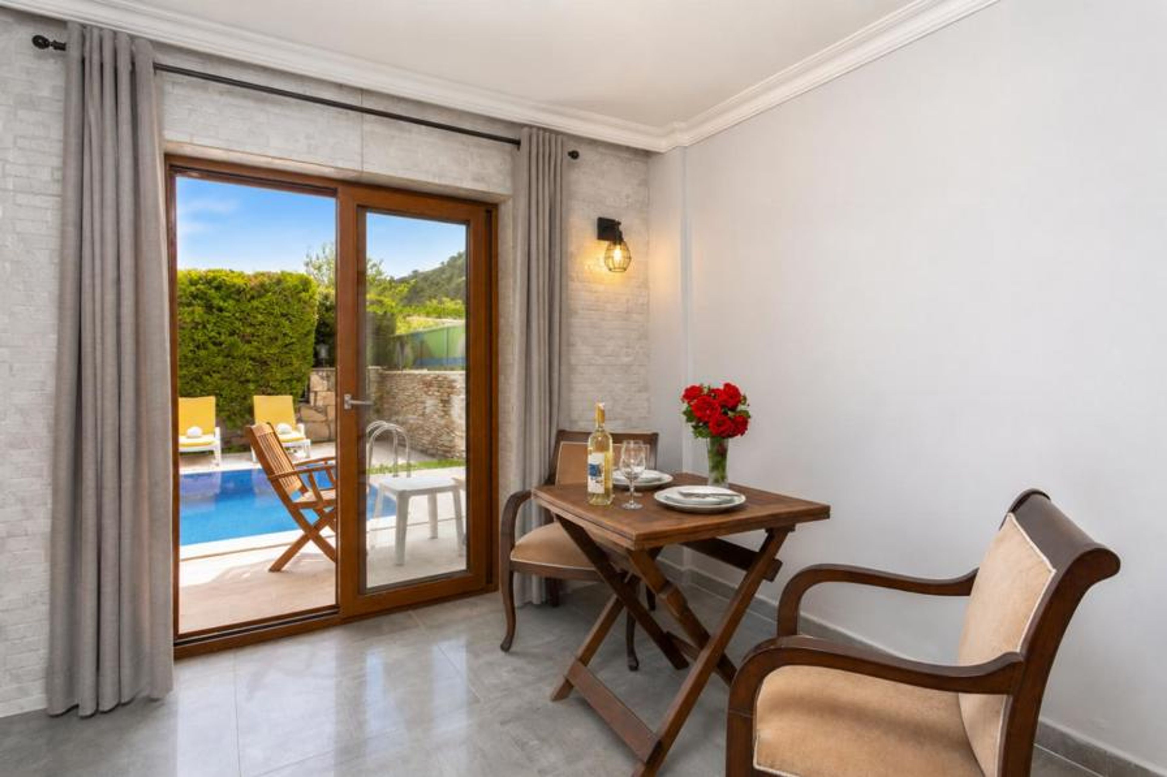 Open-plan living room with dining area, kitchen, A/C, WiFi internet, satellite TV, and pool terrace access