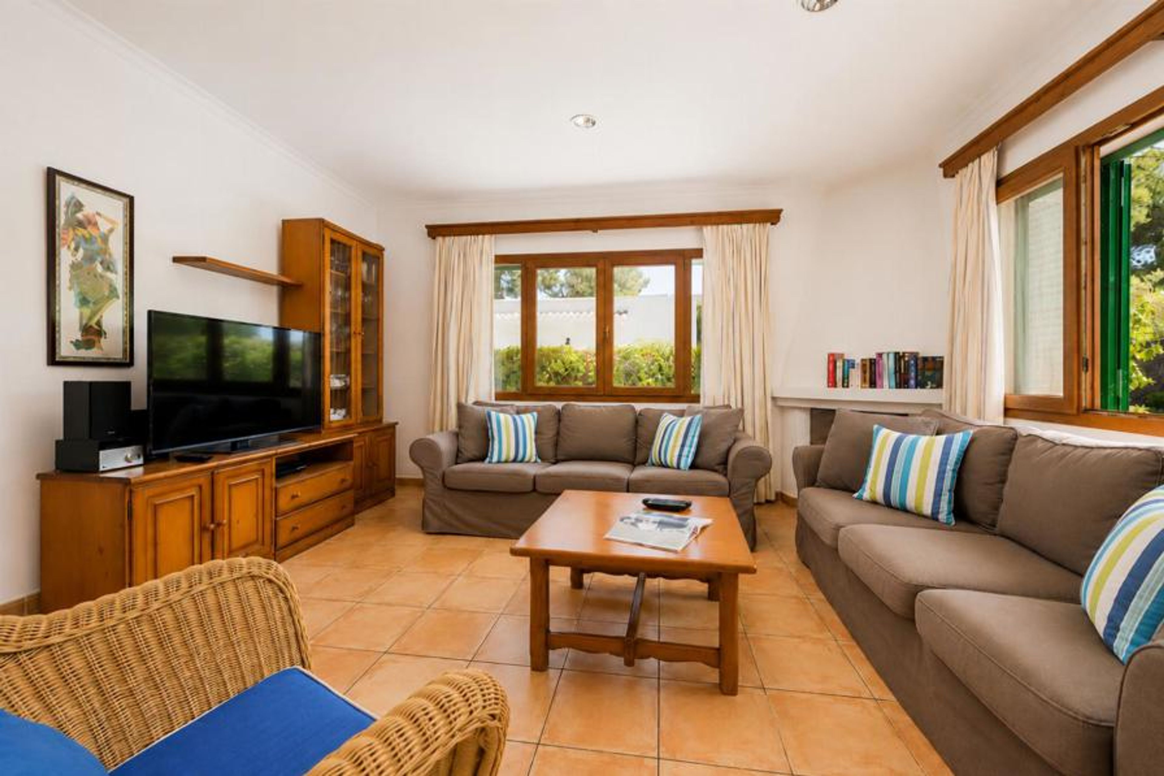 Open-plan living room with sofas, dining area, kitchen, WiFi internet, satellite TV, and terrace access