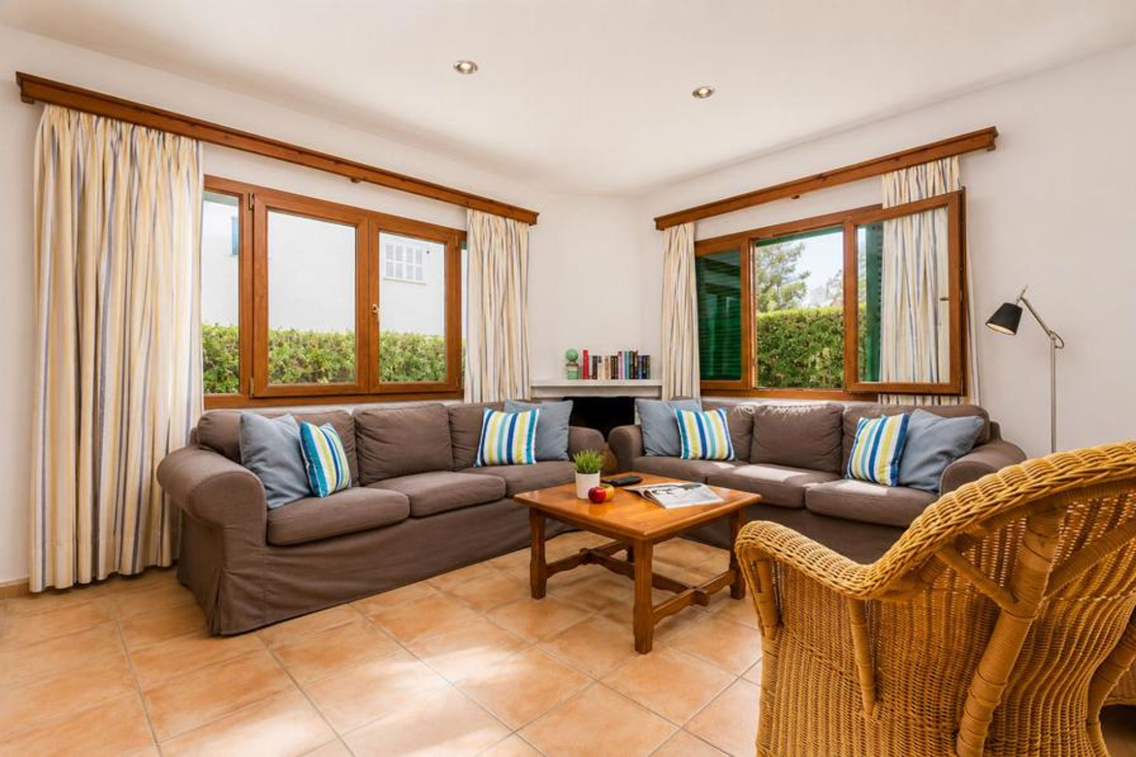 Open-plan living room with sofas, dining area, kitchen, WiFi internet, satellite TV, and terrace access