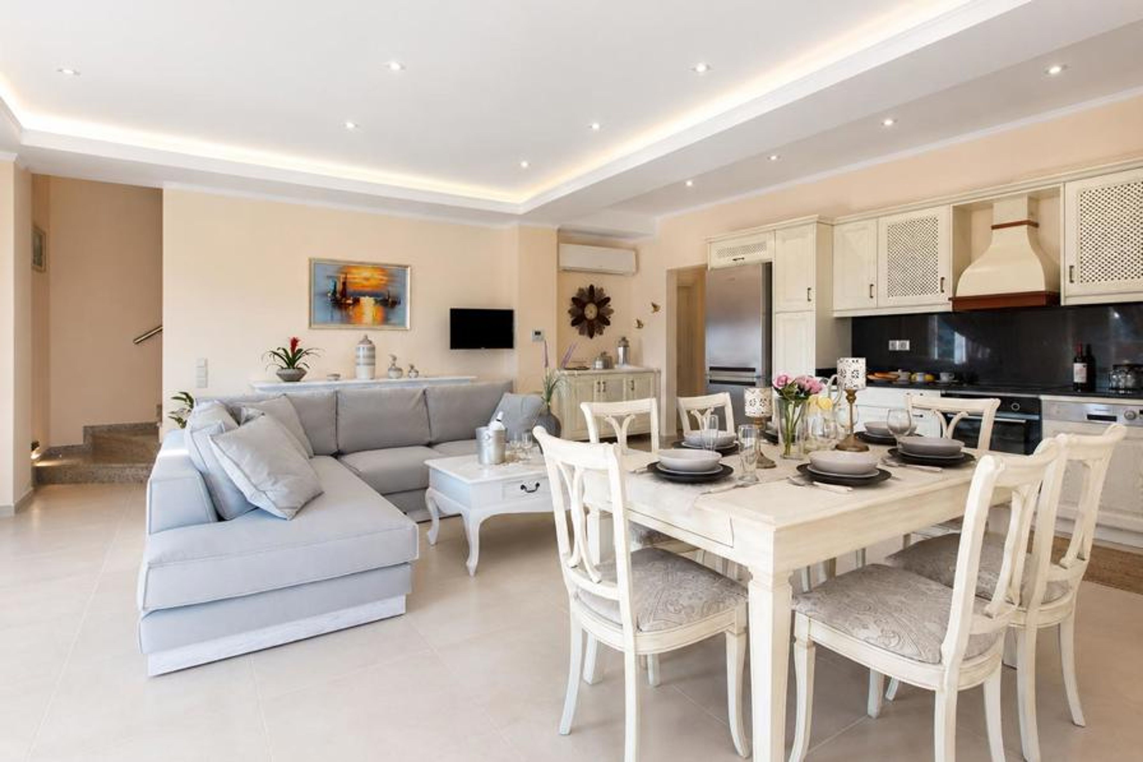 Open-plan living room with sofas, dining area, kitchen, A/C, WiFi internet, satellite TV, DVD player, and terrace access with sea views