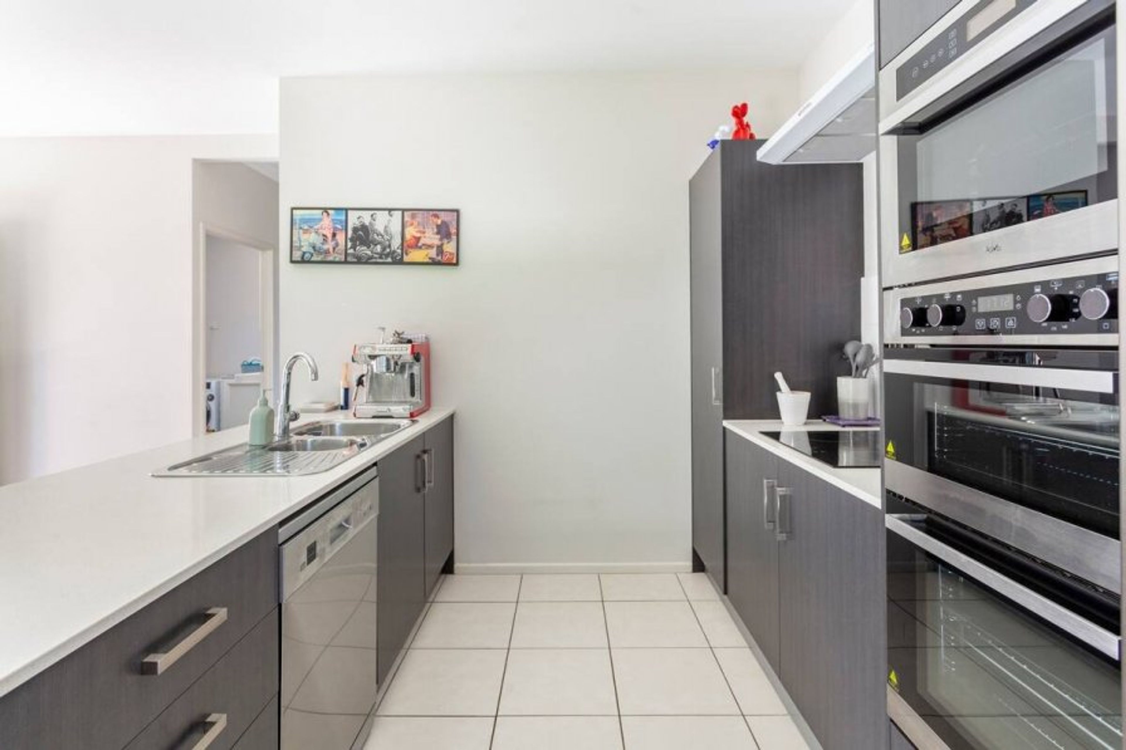 galley kitchen with stove, oven, microwave and grill 