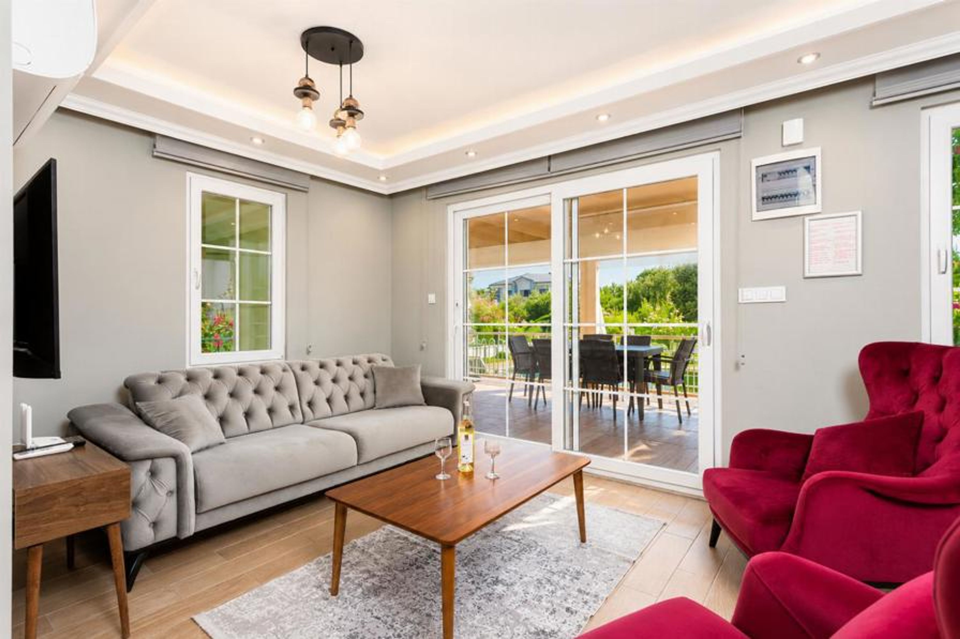 Open-plan living room with sofa, dining area, kitchen, A/C, WiFi internet, and satellite TV