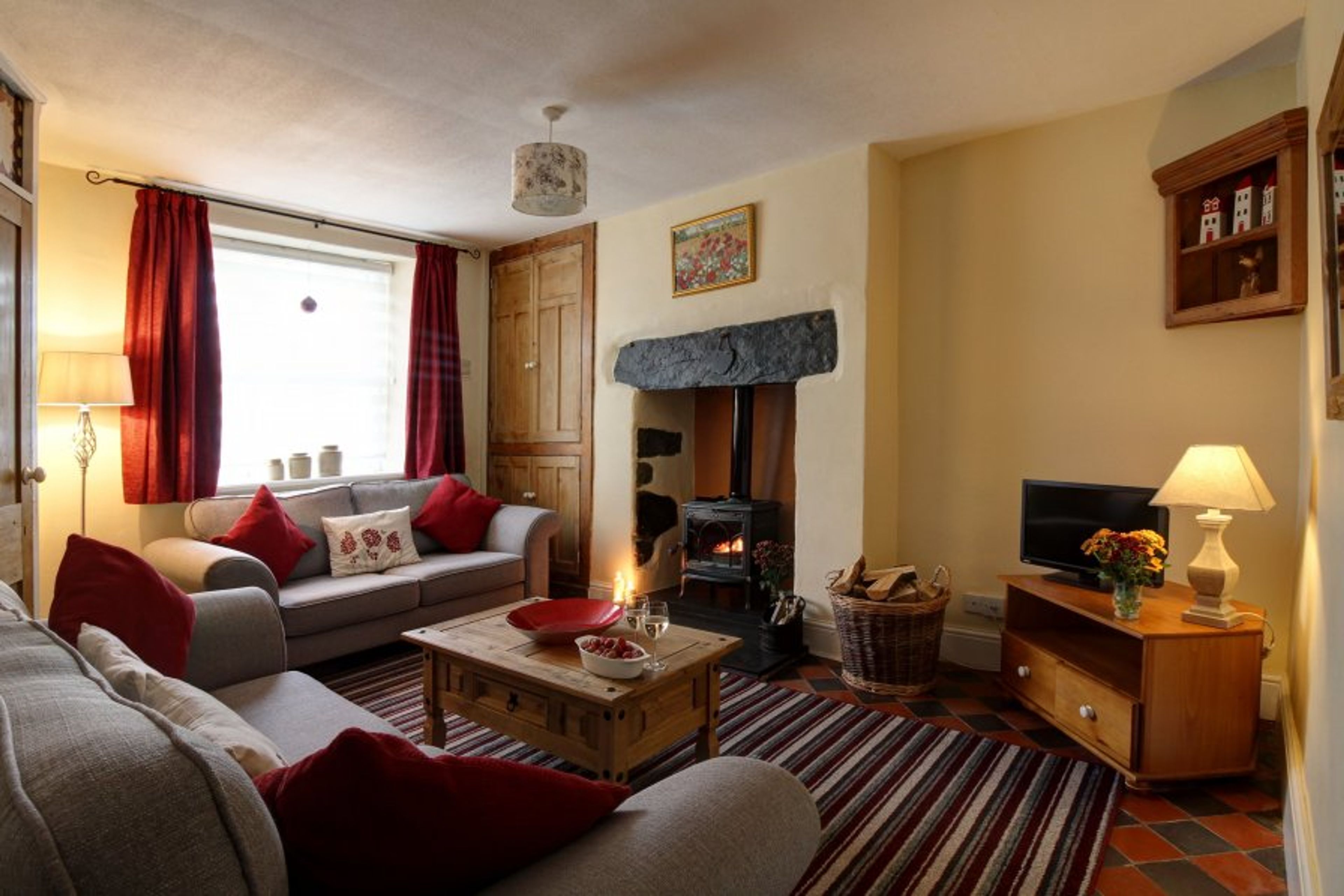 Comfortable seating area with log burner and smart TV