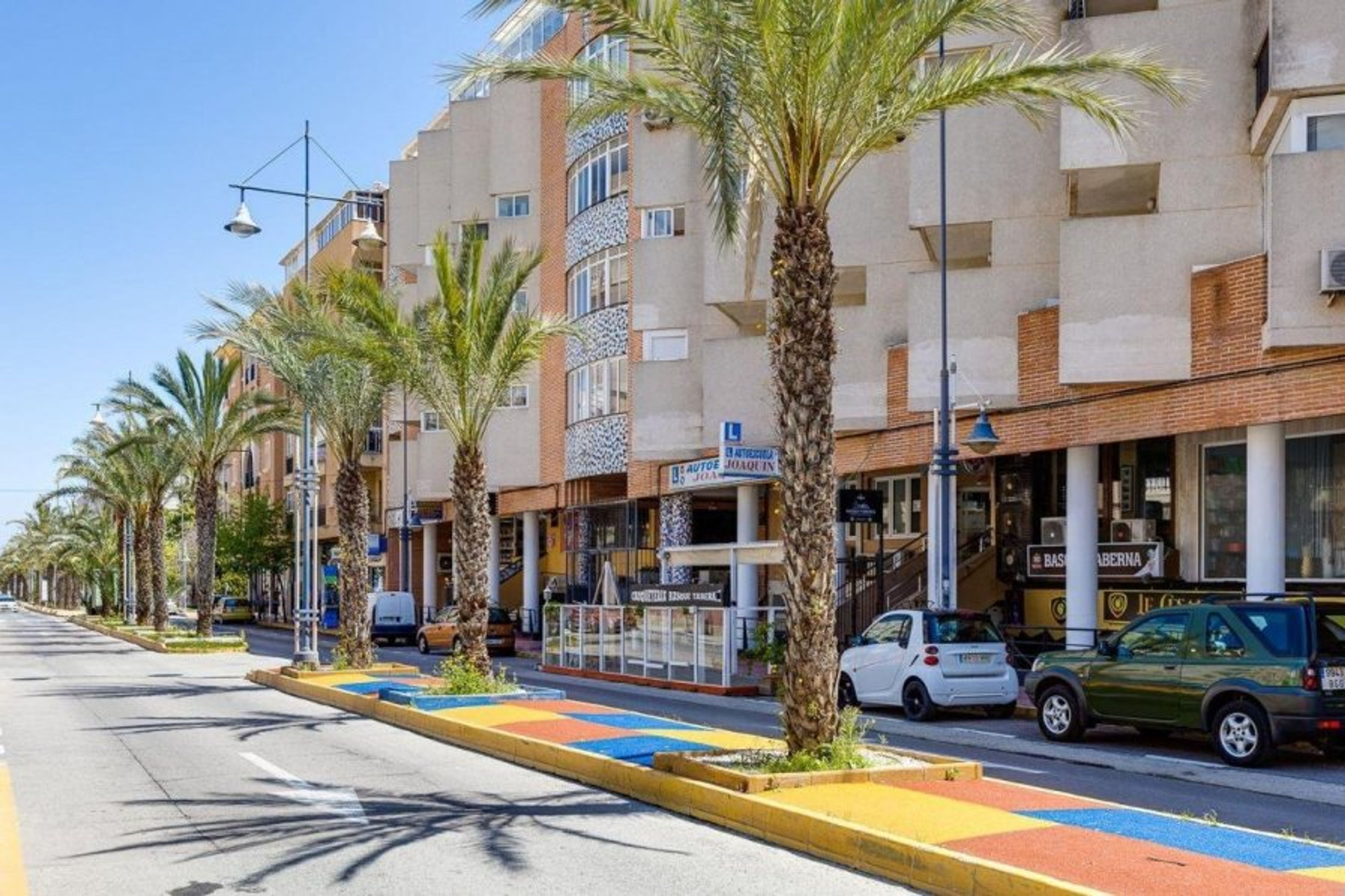 The magnificient building lying on the beautiful street going to beach