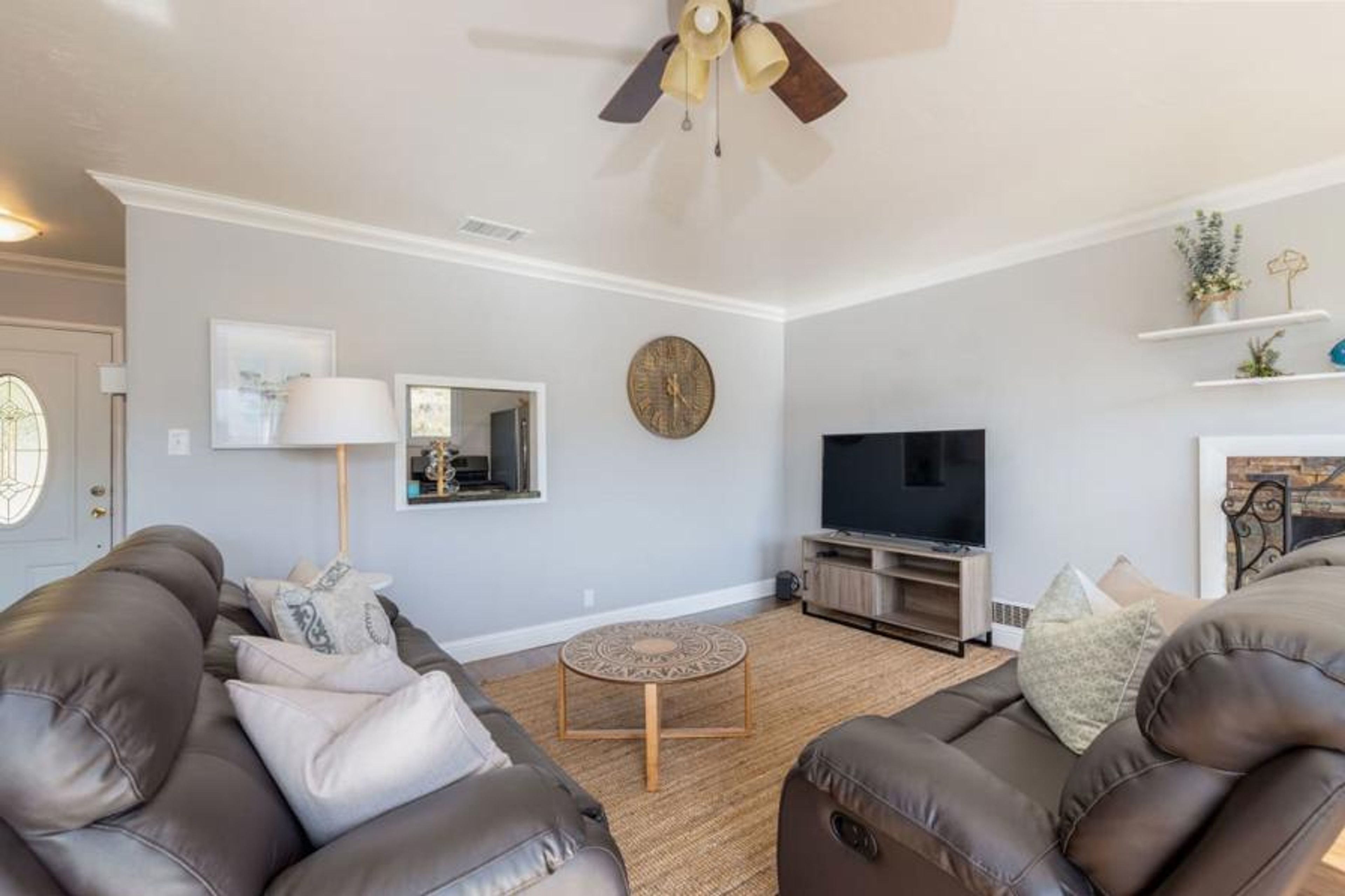 Inviting living room with sofa, fireplace, and entertainment
