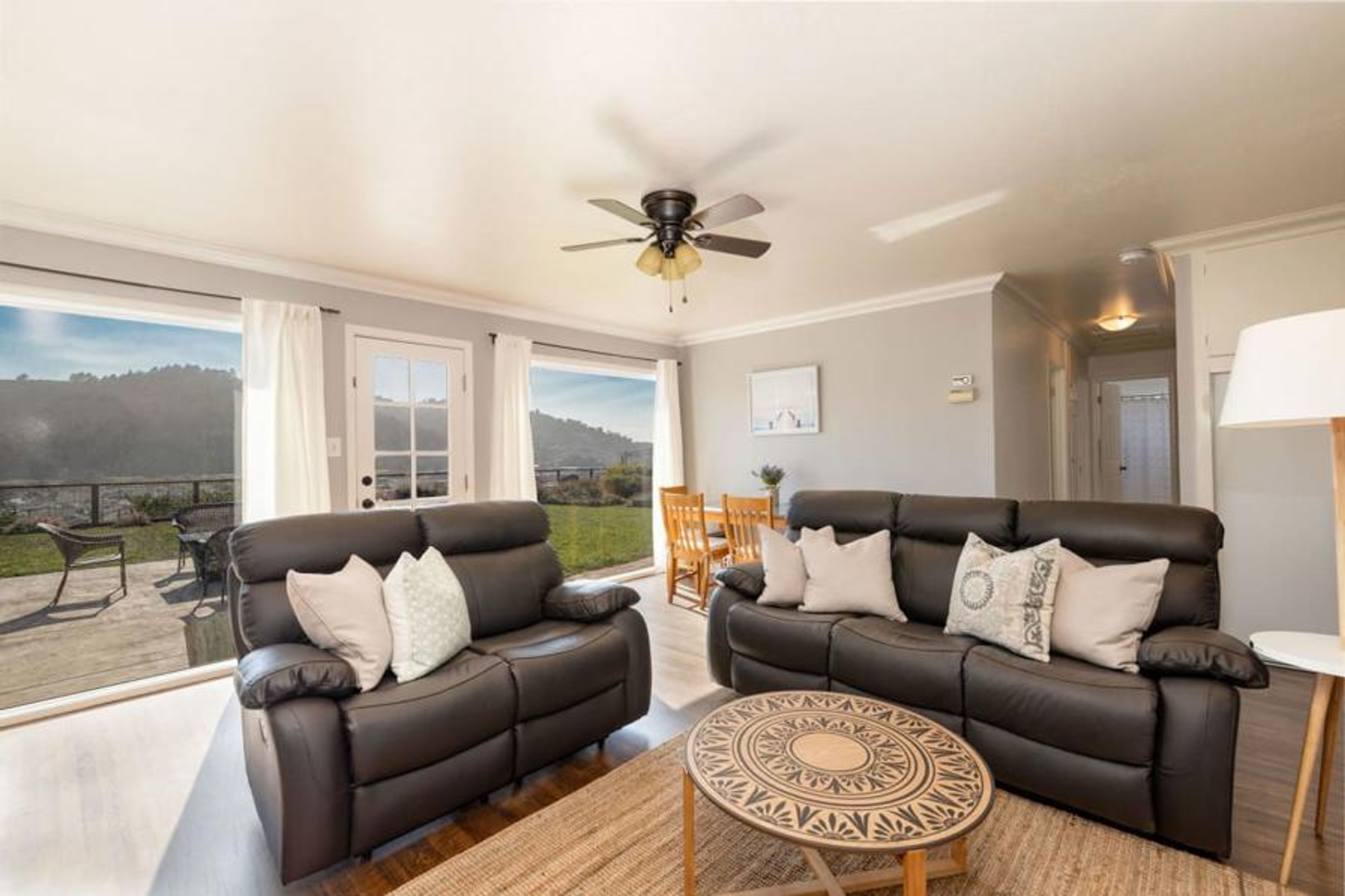 Refined sitting area with sofas, table, and window views