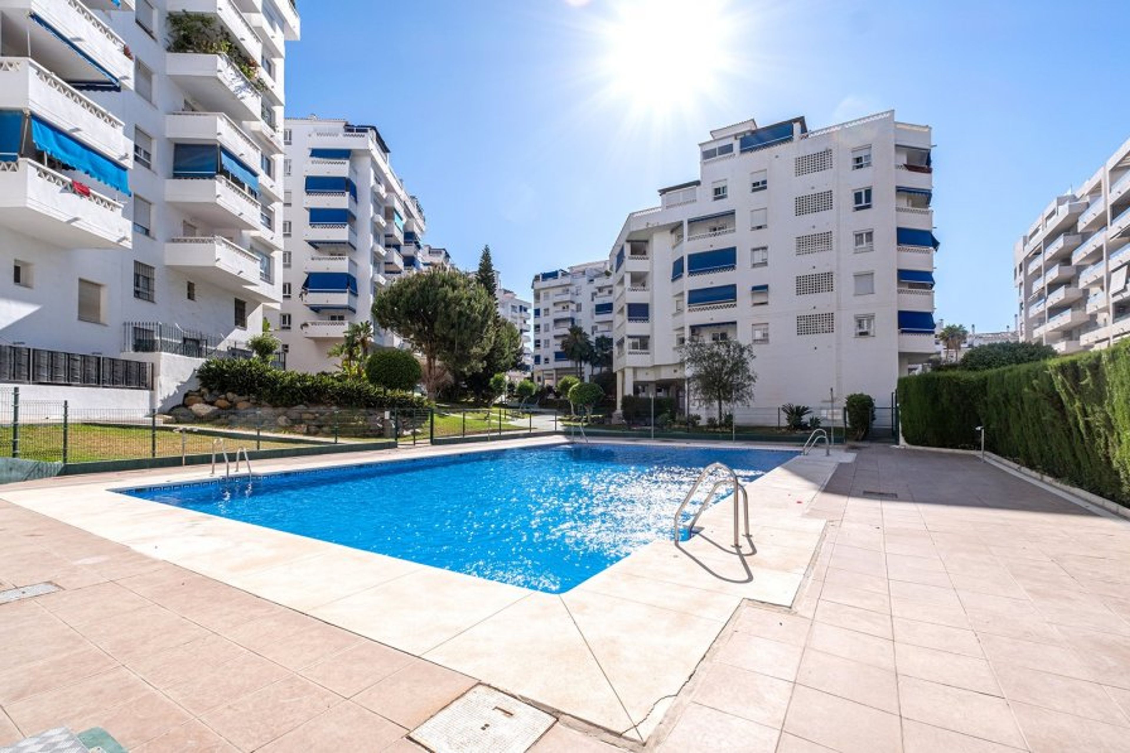Swimming pool looking towards the apartment building.
