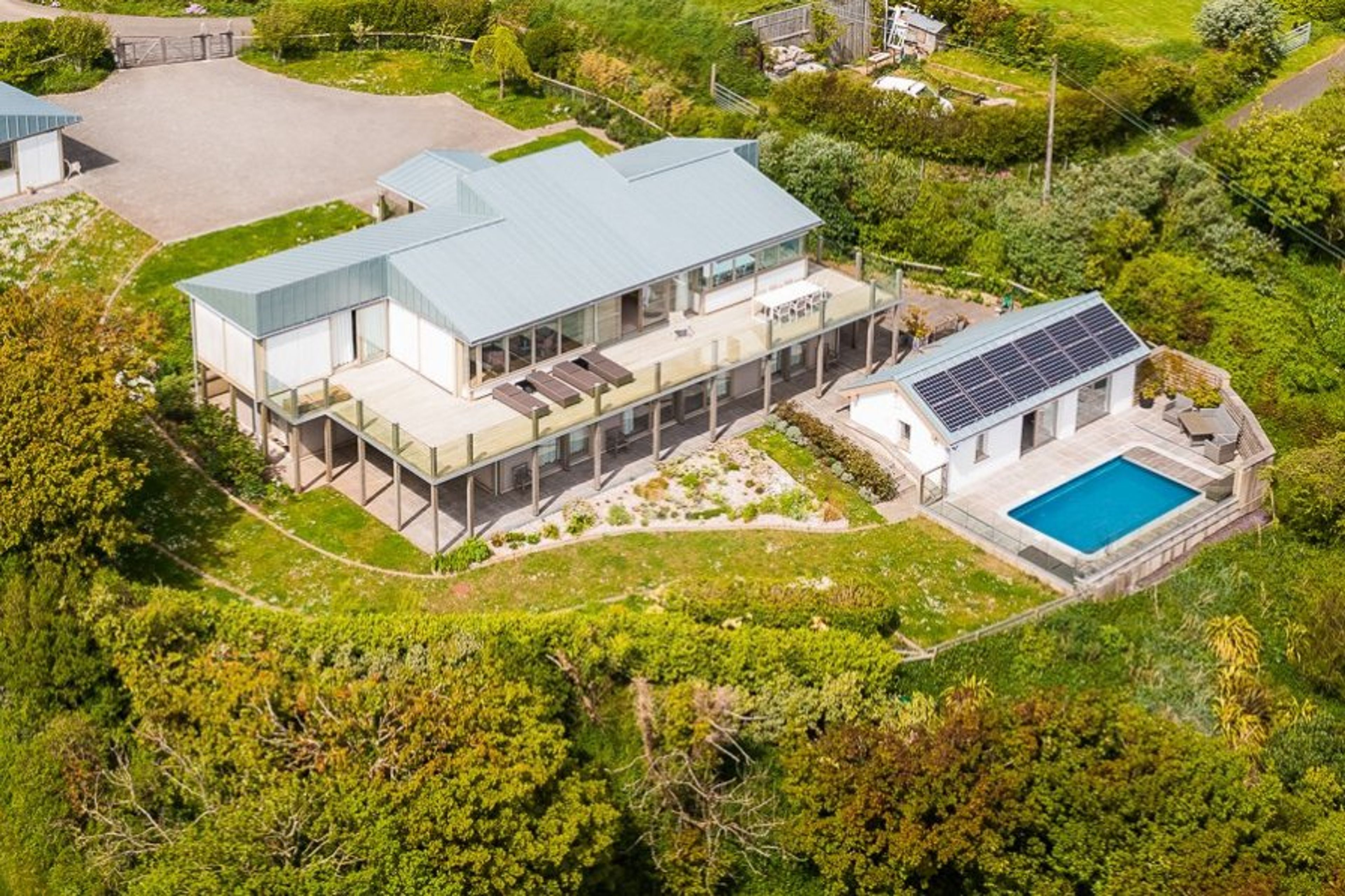 Aerial shot, showing the house, pool, garden and drive.