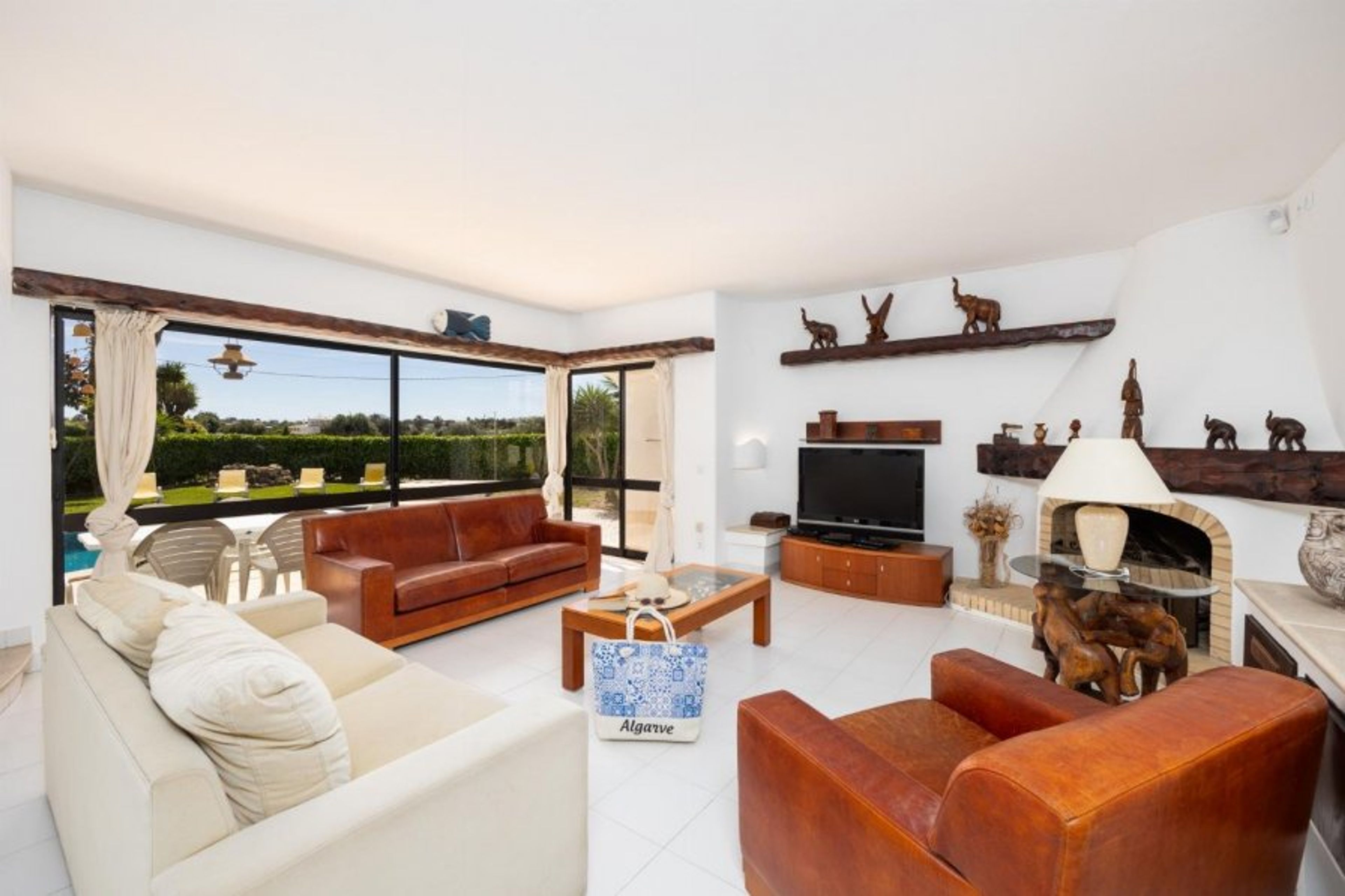 Living room with sofas, dining area, ornamental fireplace, A/C, WiFi internet, and satellite TV