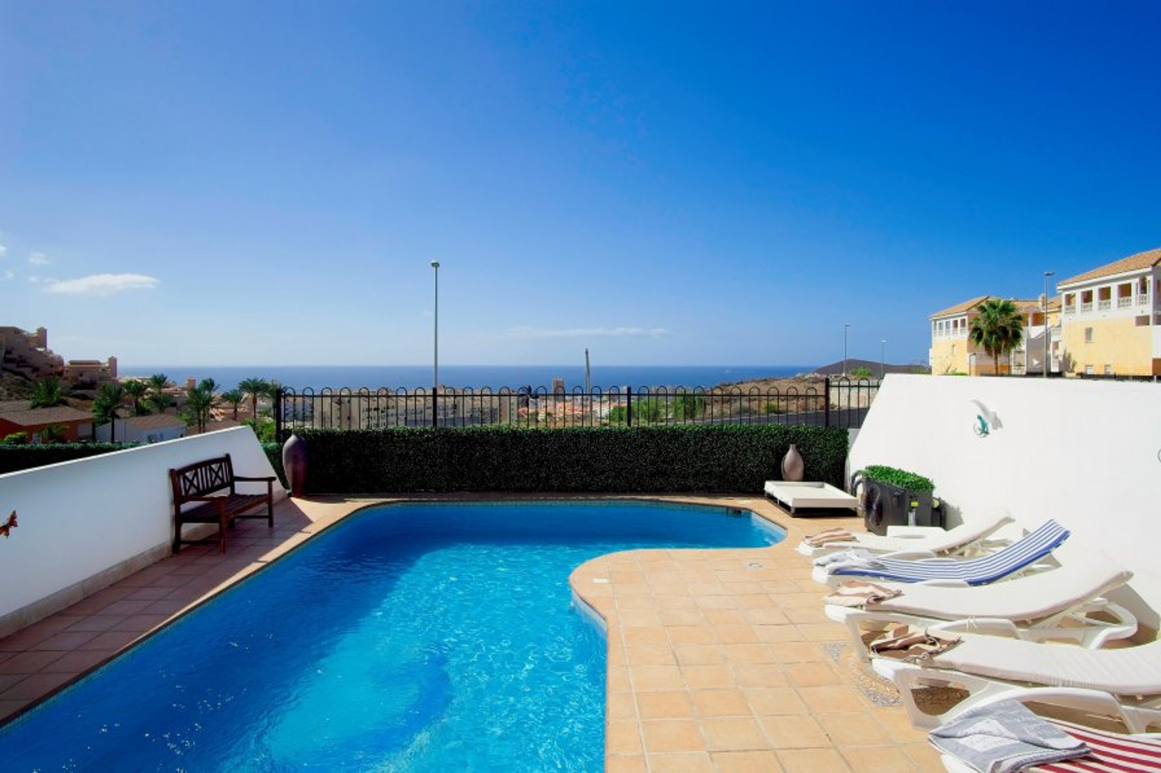 Swimming pool with sea views in the distance