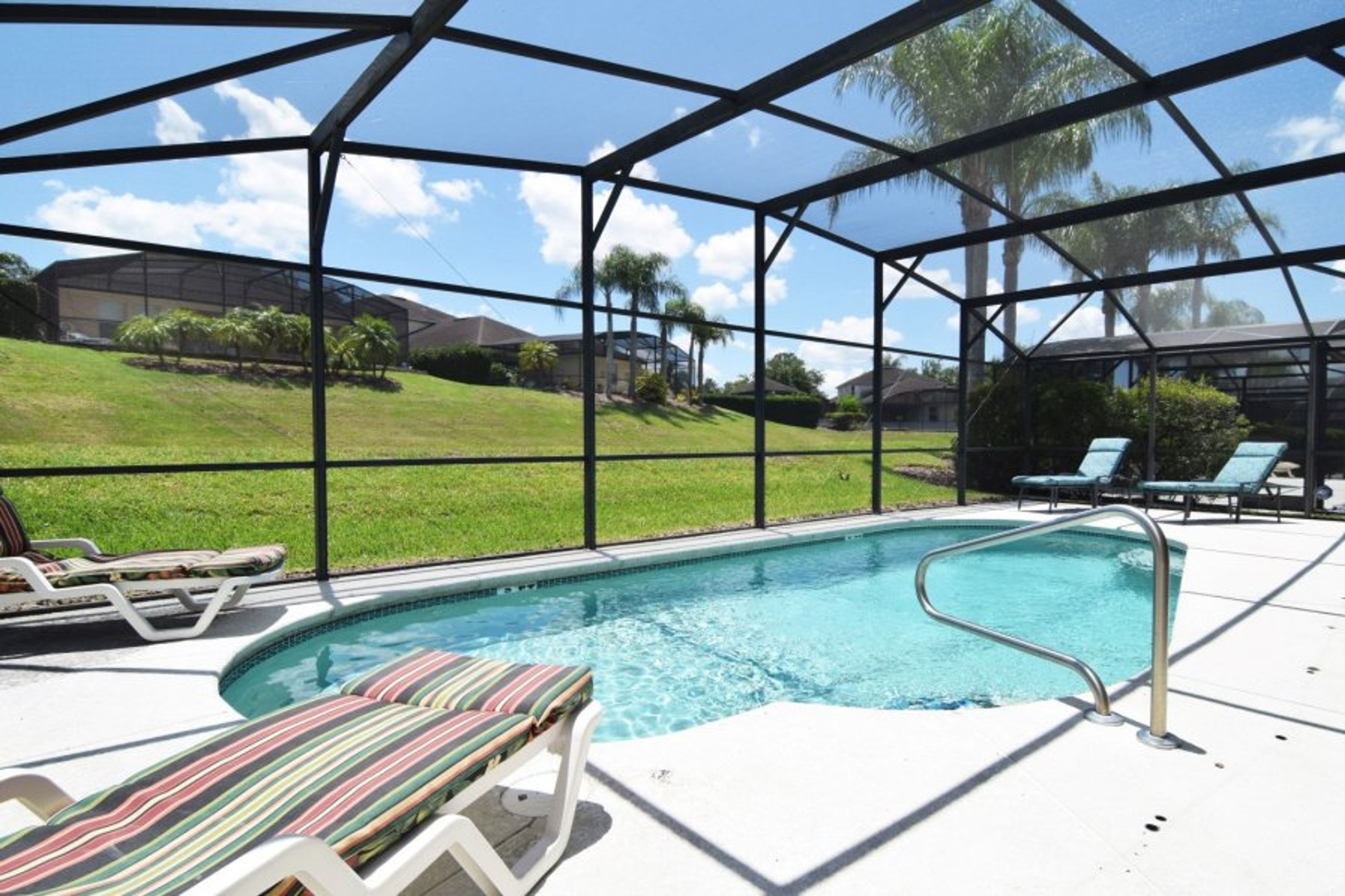 Great pool deck with large private pool, loungers, shaded dining area