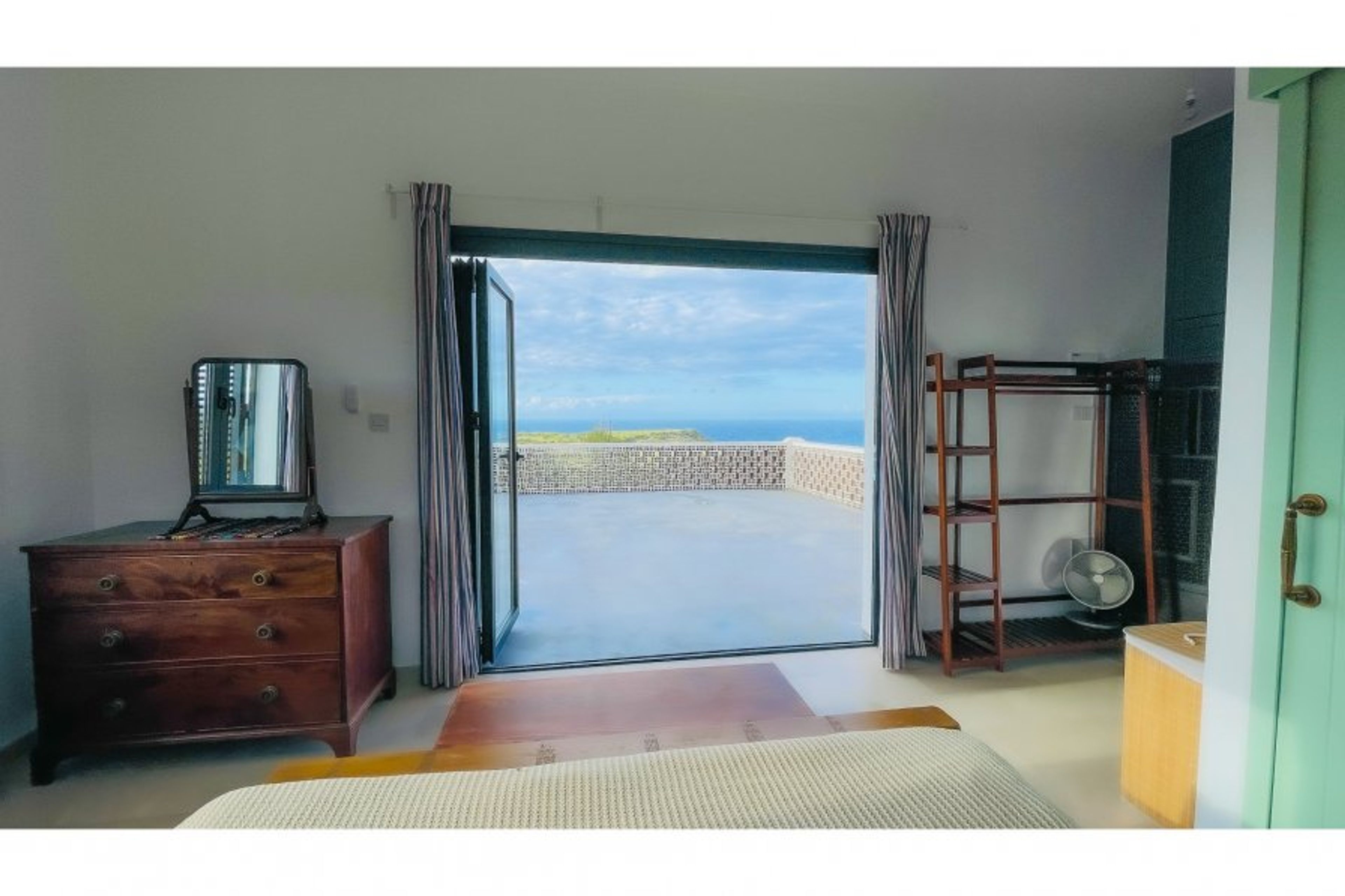 Upstairs bedroom with stunning views down to the sea across our land