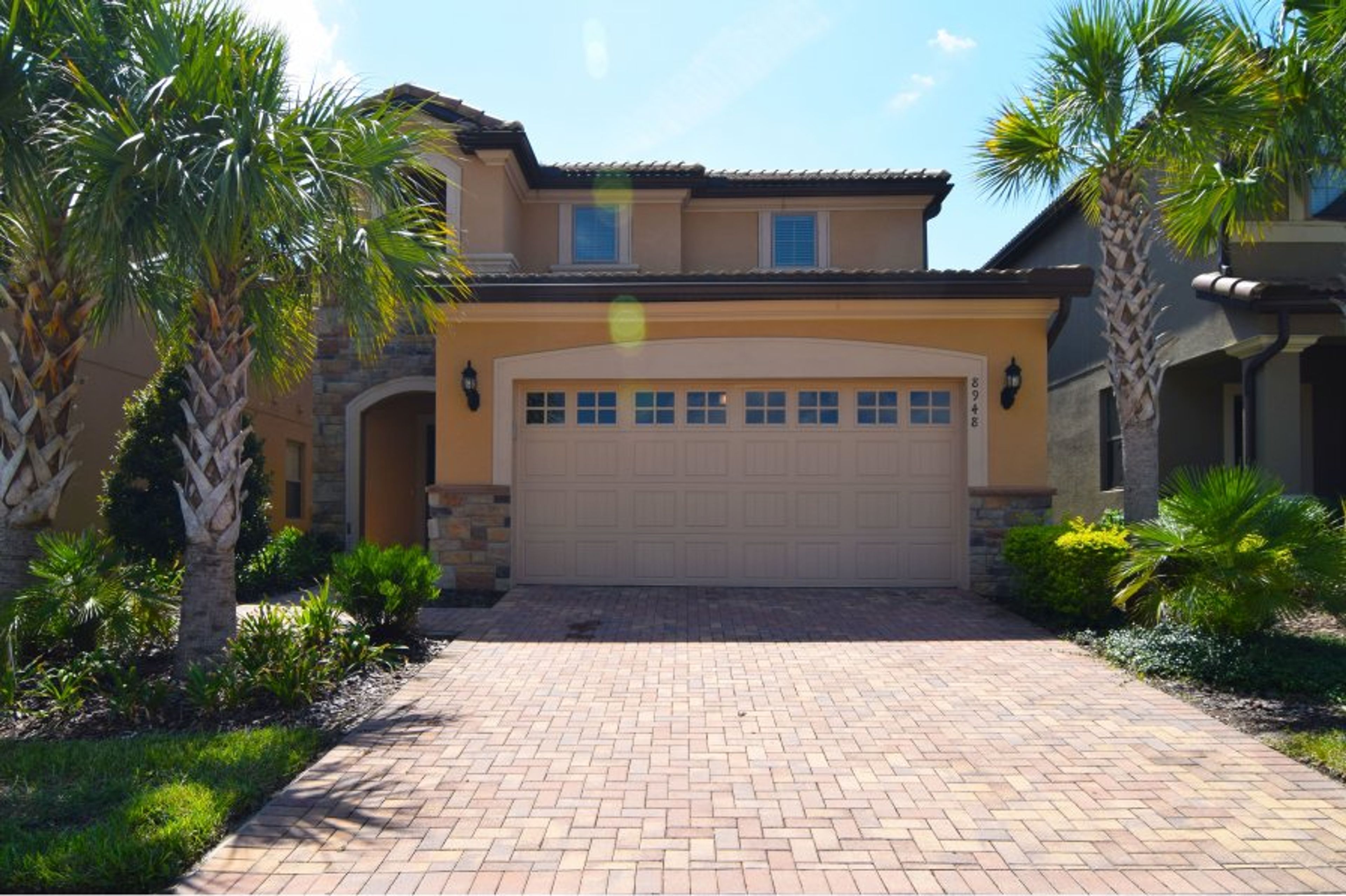 Front of home with paved driveway for two vehicles
