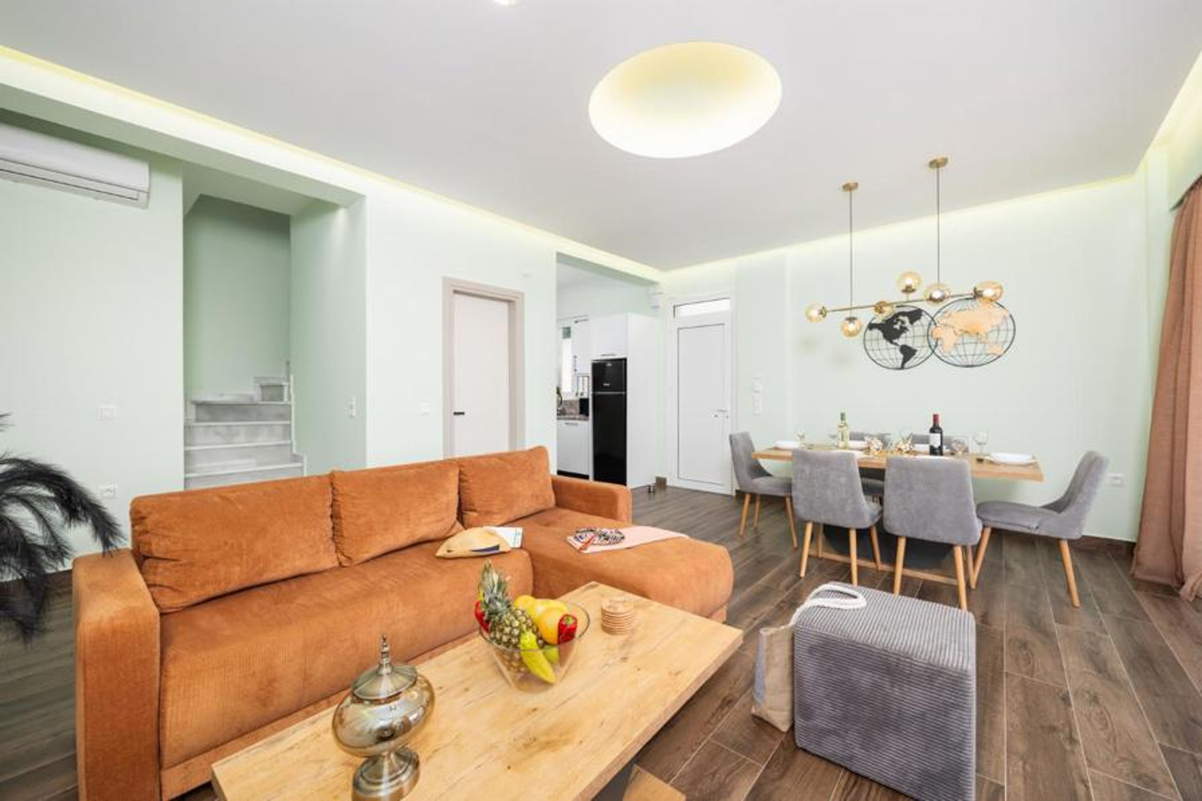 Open-plan living room with sofa, dining area, kitchen, A/C, WiFi internet, satellite TV, and sea views