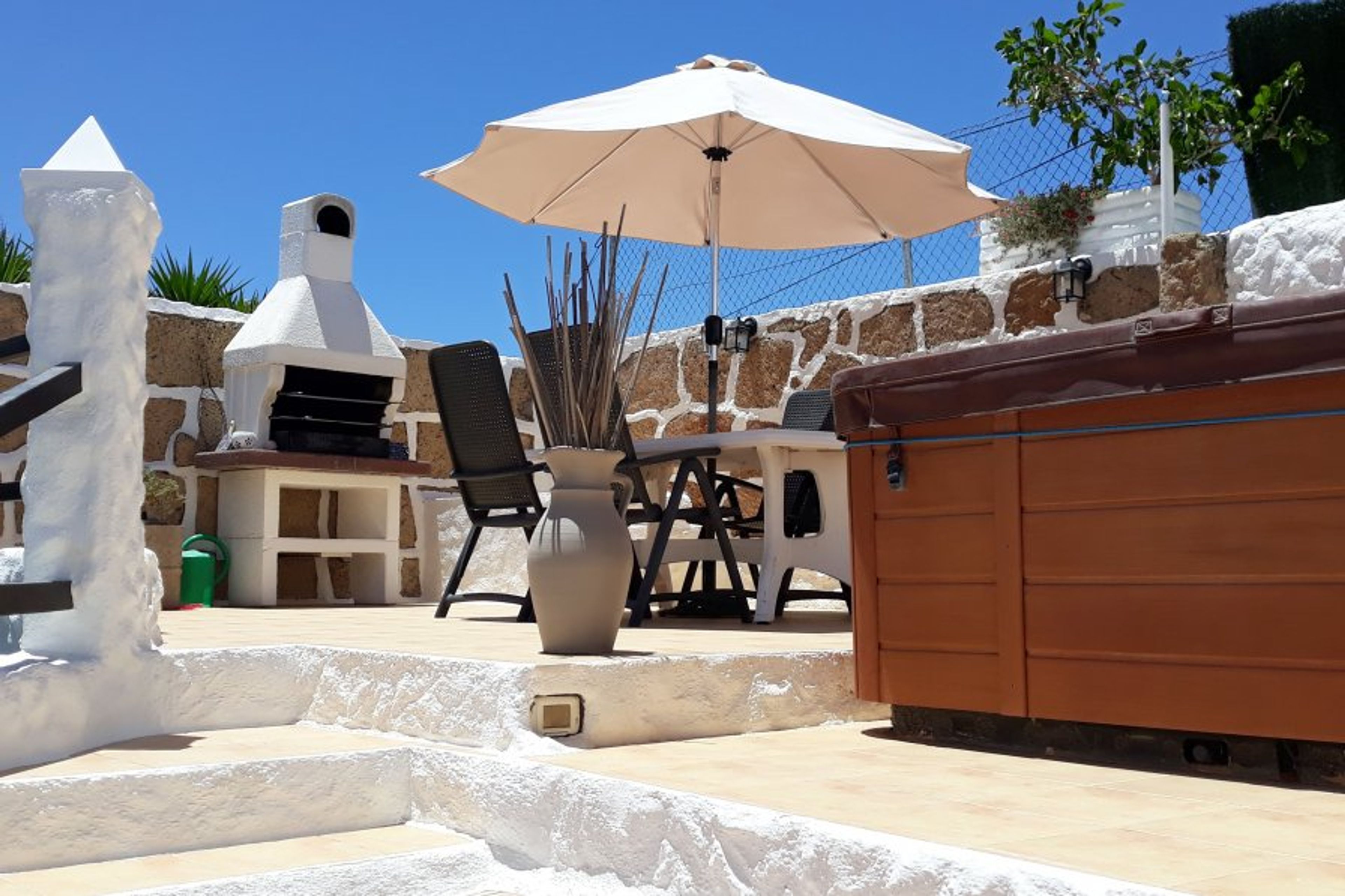 Top terrace with dining area & BBQ area. Hot tub is constantly heated