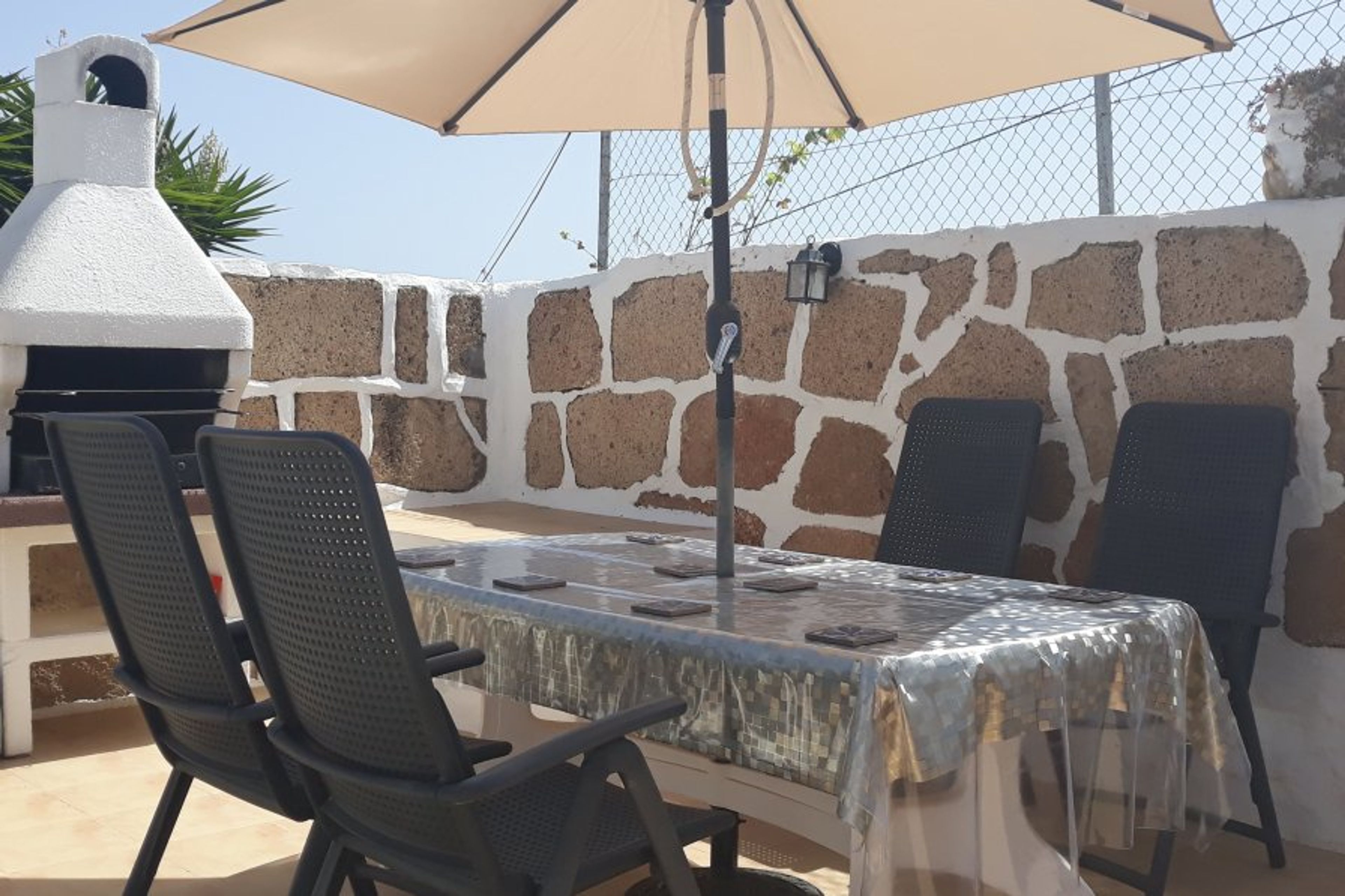 Alfresco dining area with BBQ. Some coals are provided