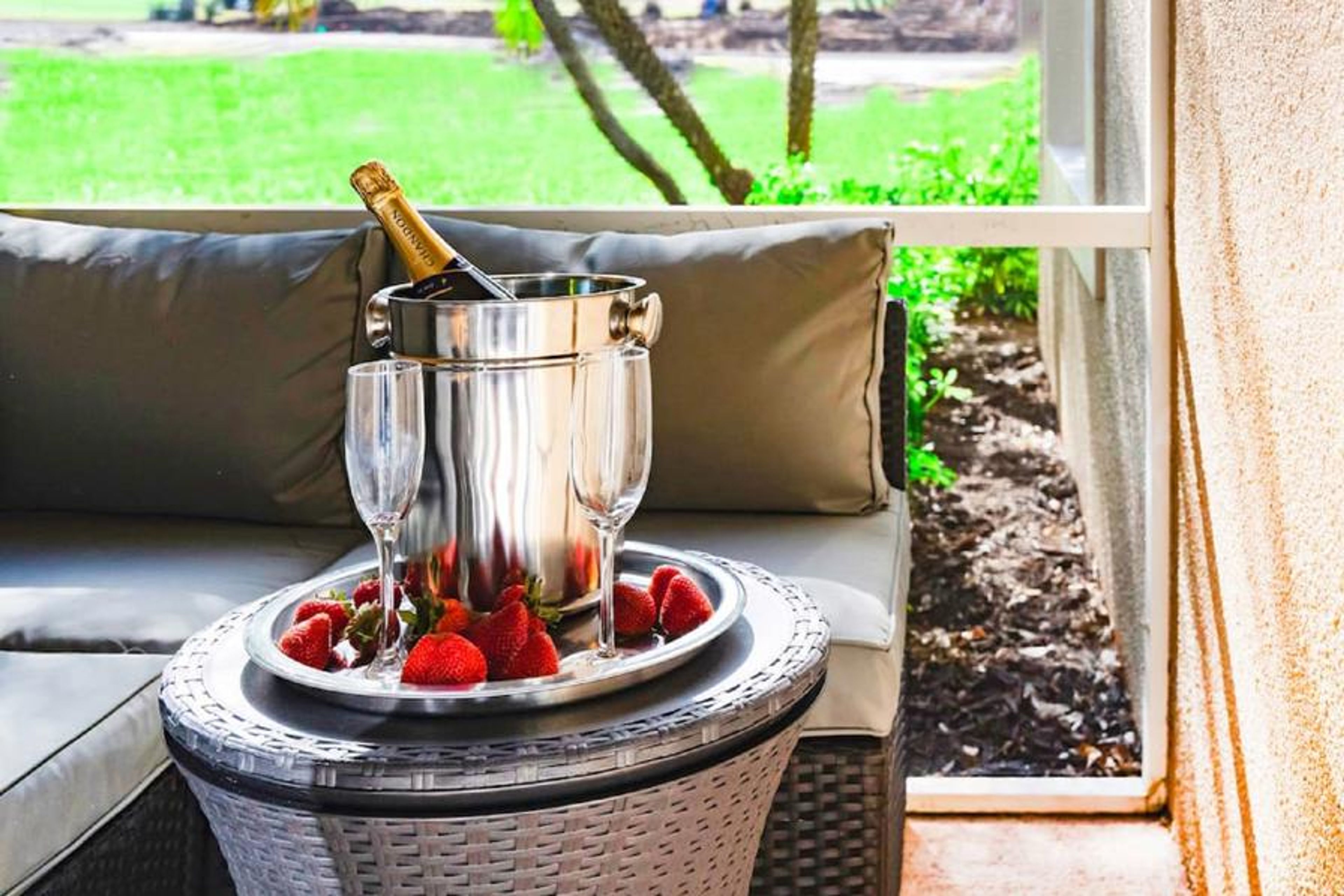 Outdoor Livingroom Patio with TV on wall and overlooking PGA Clubhouse and Learning Center