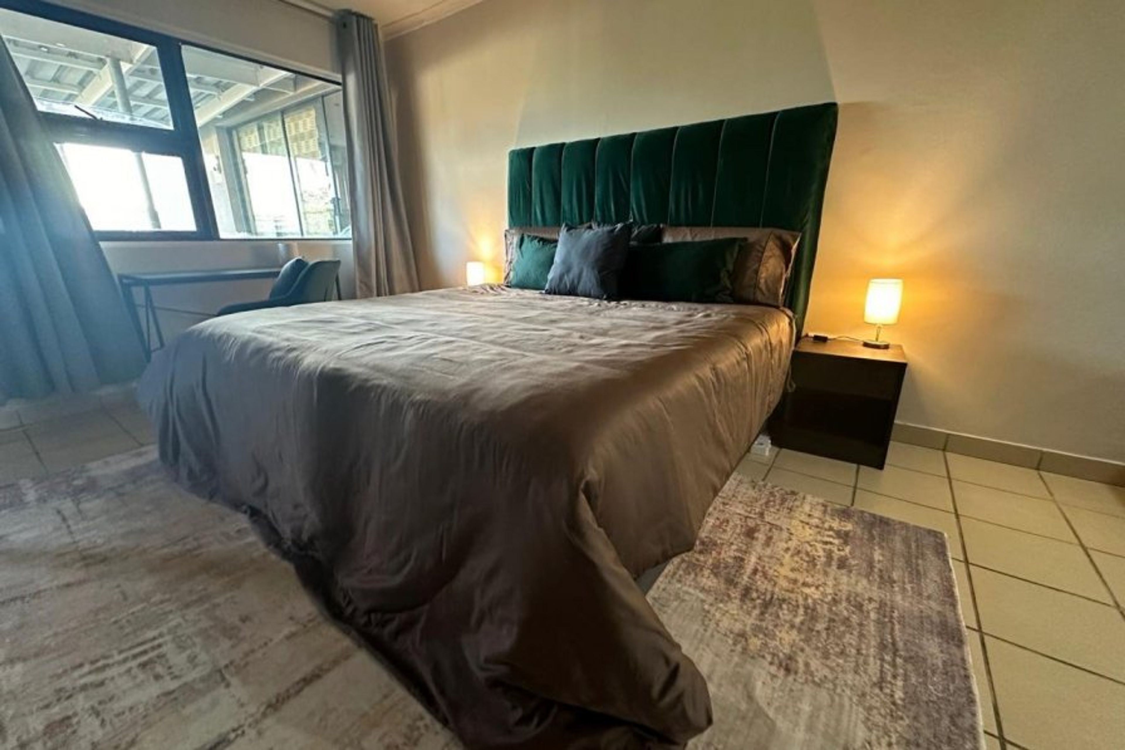 Bedroom with lots of light and work desk