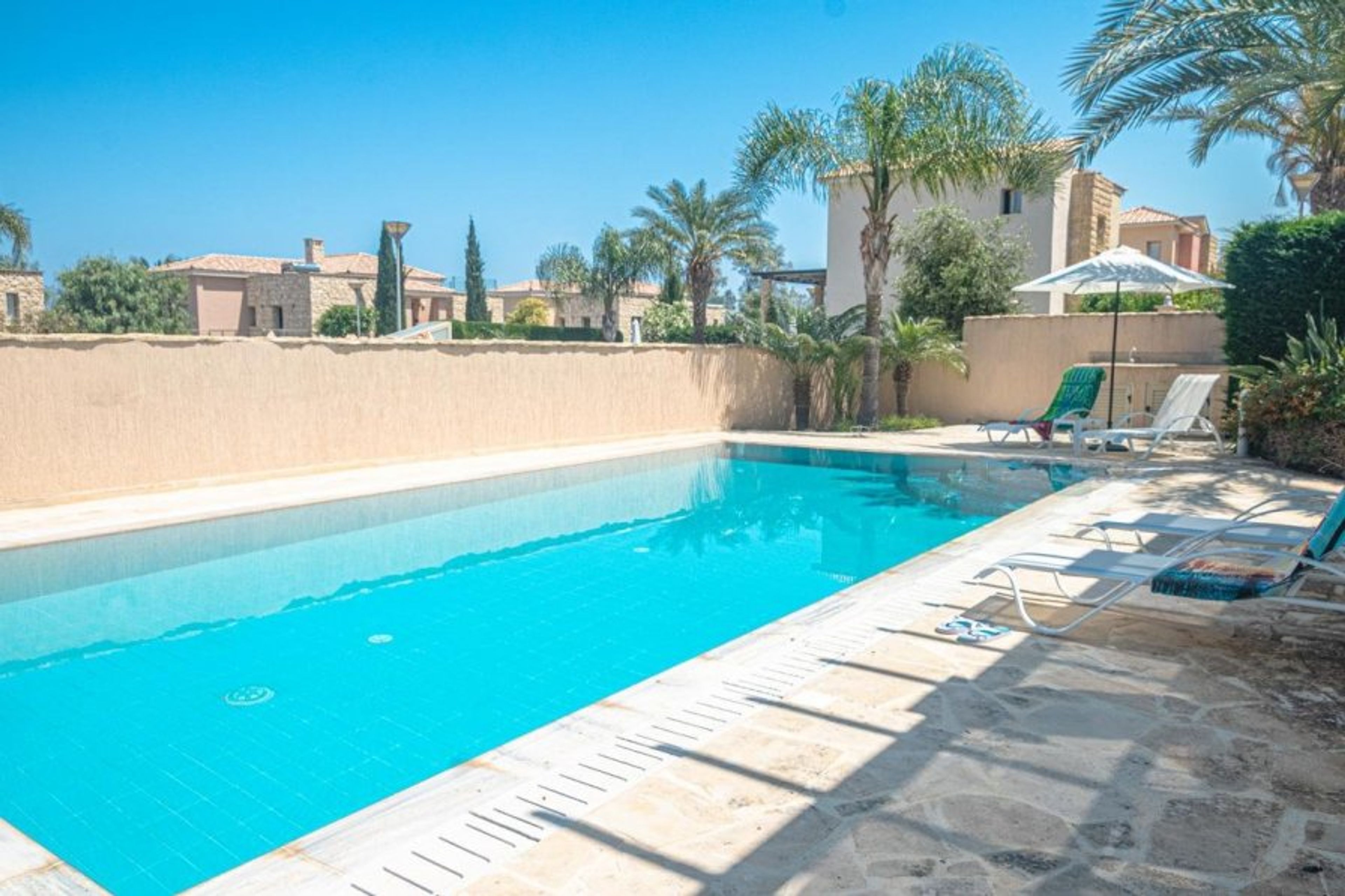 Private pool with sun loungers and parasols
