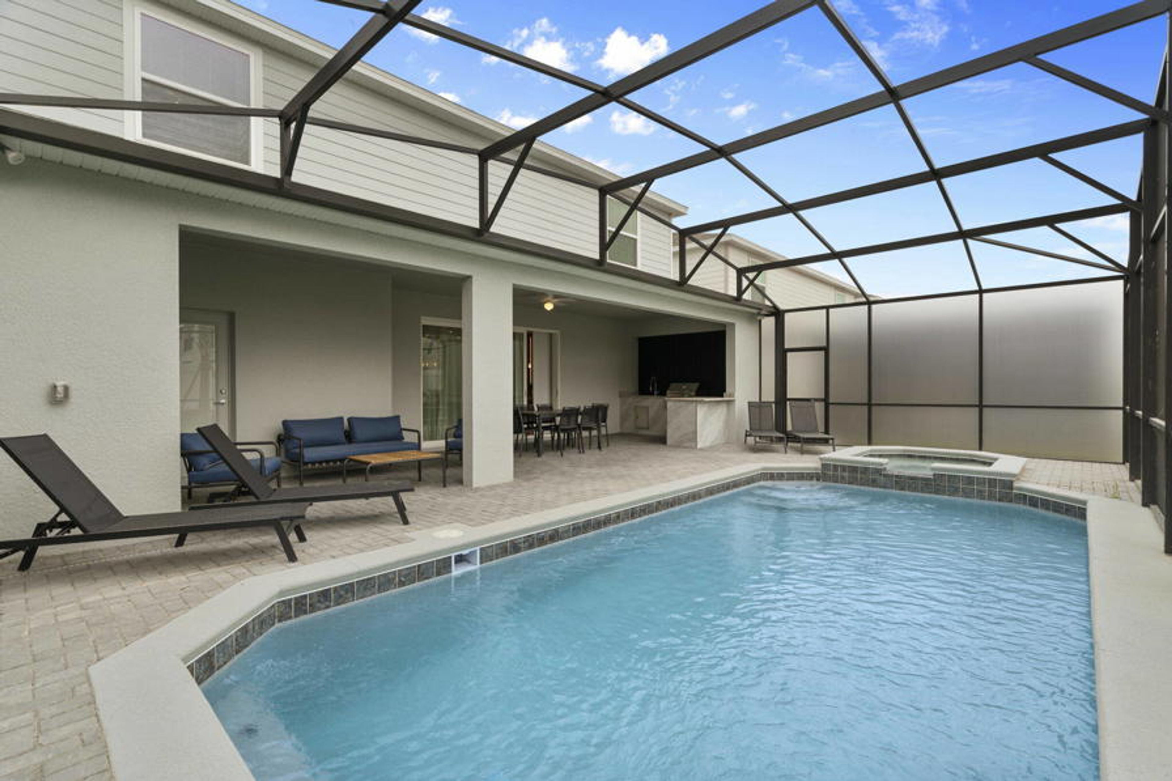 Step into a sunlit oasis featuring a refreshing pool surrounded by sleek lounge chairs, perfect for unwinding after a day of adventure. The modern canopy allows for outdoor enjoyment while providing a sense of privacy and comfort.
