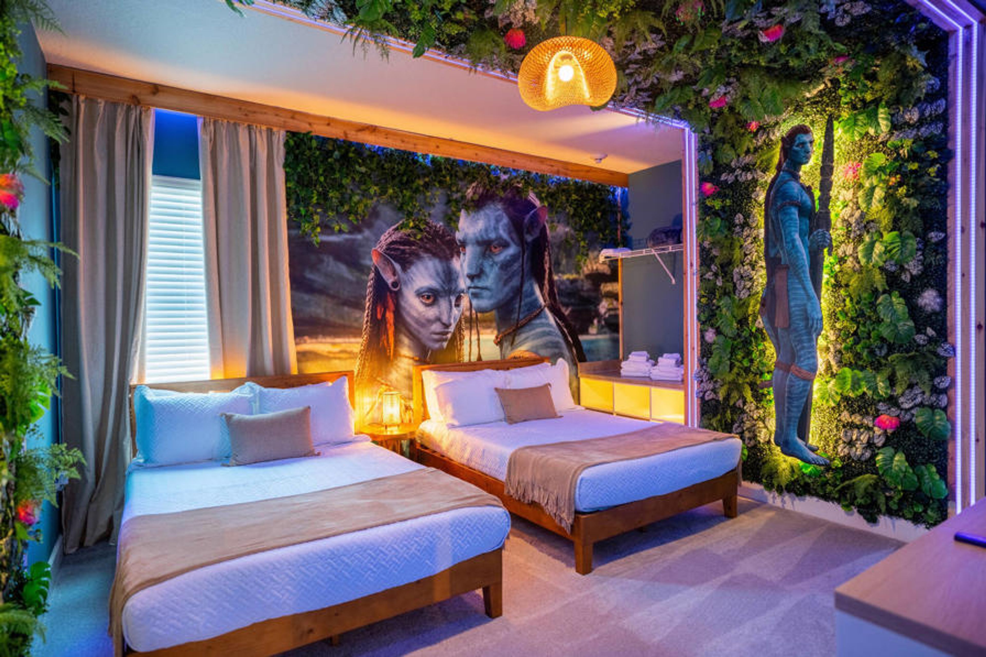 Step into a vibrant bedroom featuring two cozy beds framed by lush greenery and an eye-catching mural that adds a splash of creativity. The soft lighting and warm textures create a welcoming atmosphere, perfect for relaxation.