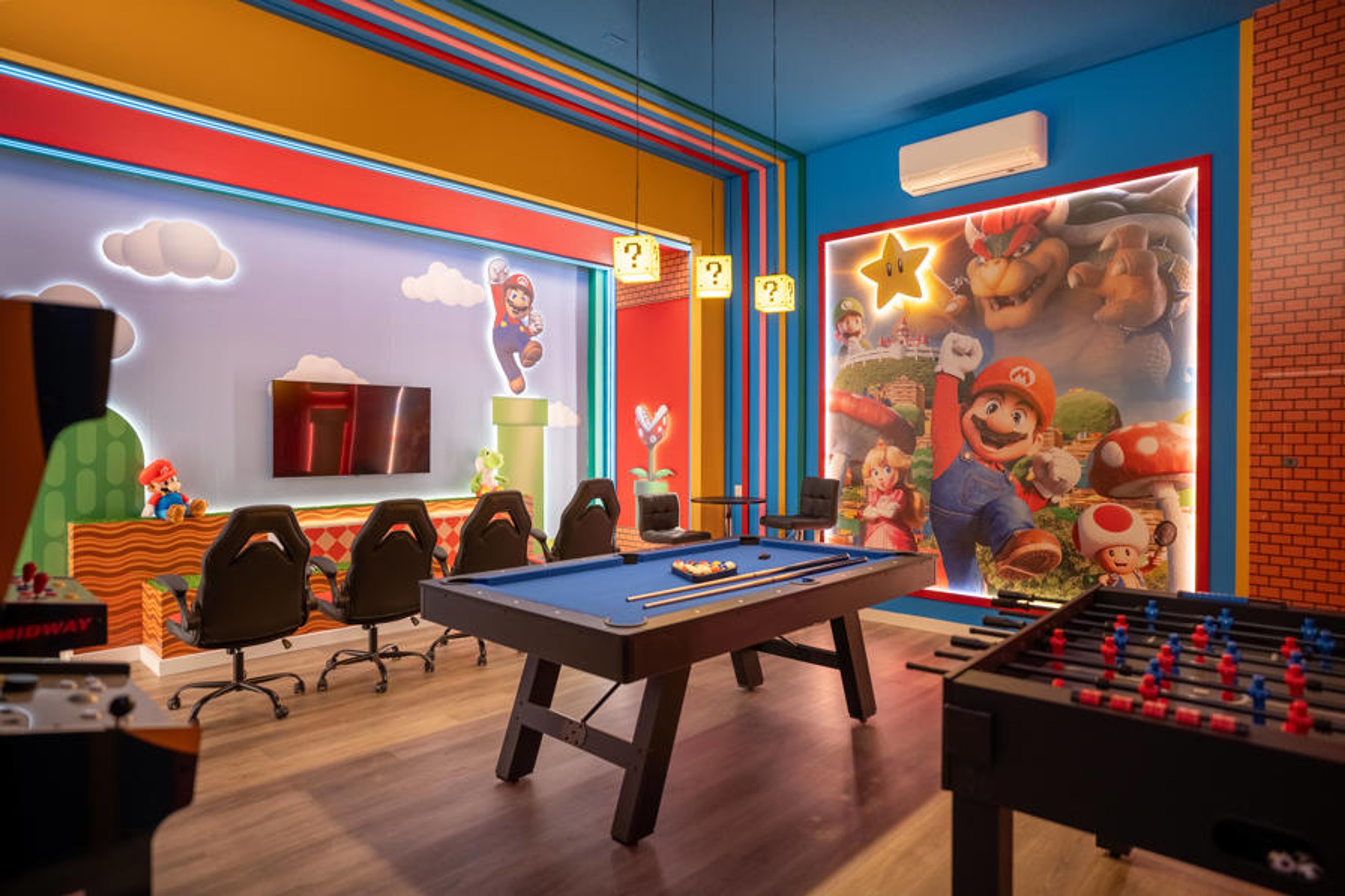 Enter our lively game room adorned with playful murals that evoke nostalgia. Engage in friendly competition at the sleek pool table or challenge friends at the foosball table, all under inviting pendant lighting.