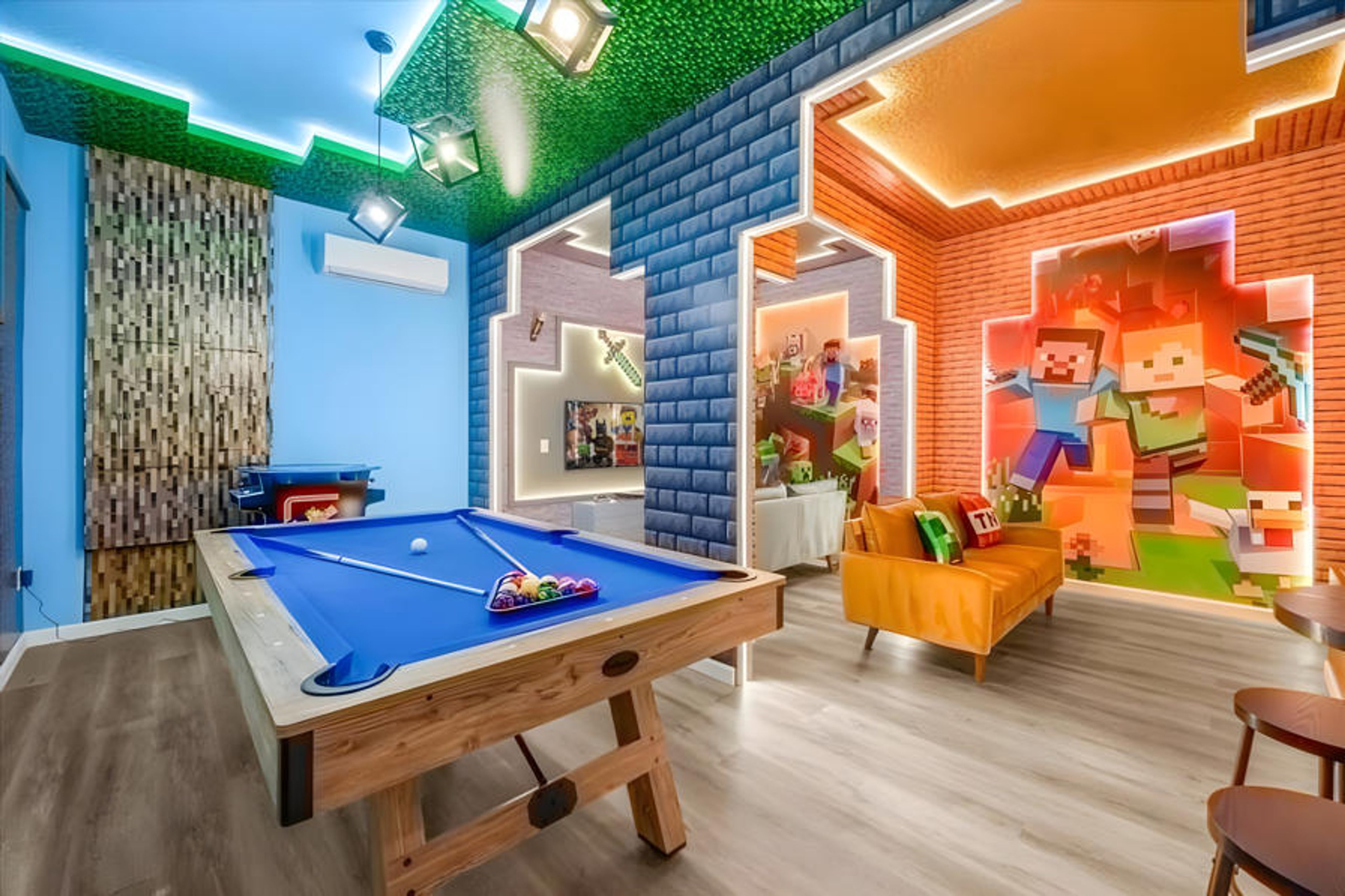 Enter our lively game room, featuring bright blue walls and a playful green ceiling with a custom mural that inspires creativity. Enjoy a game at the sleek pool table or unwind on the cozy orange couch for an entertaining evening.