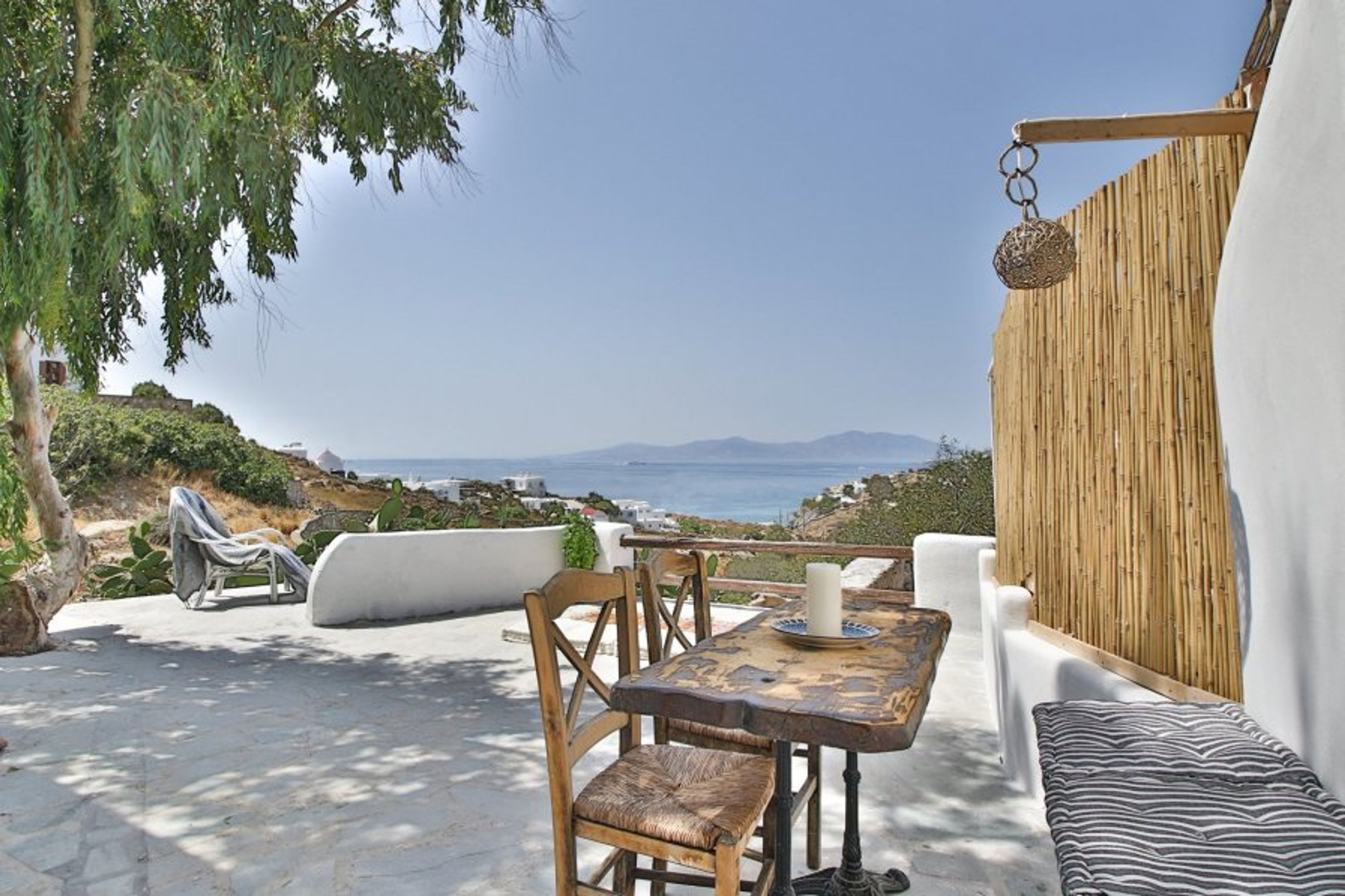 outdoor terrace with table, seating +2 chairs and 2 sunloungers