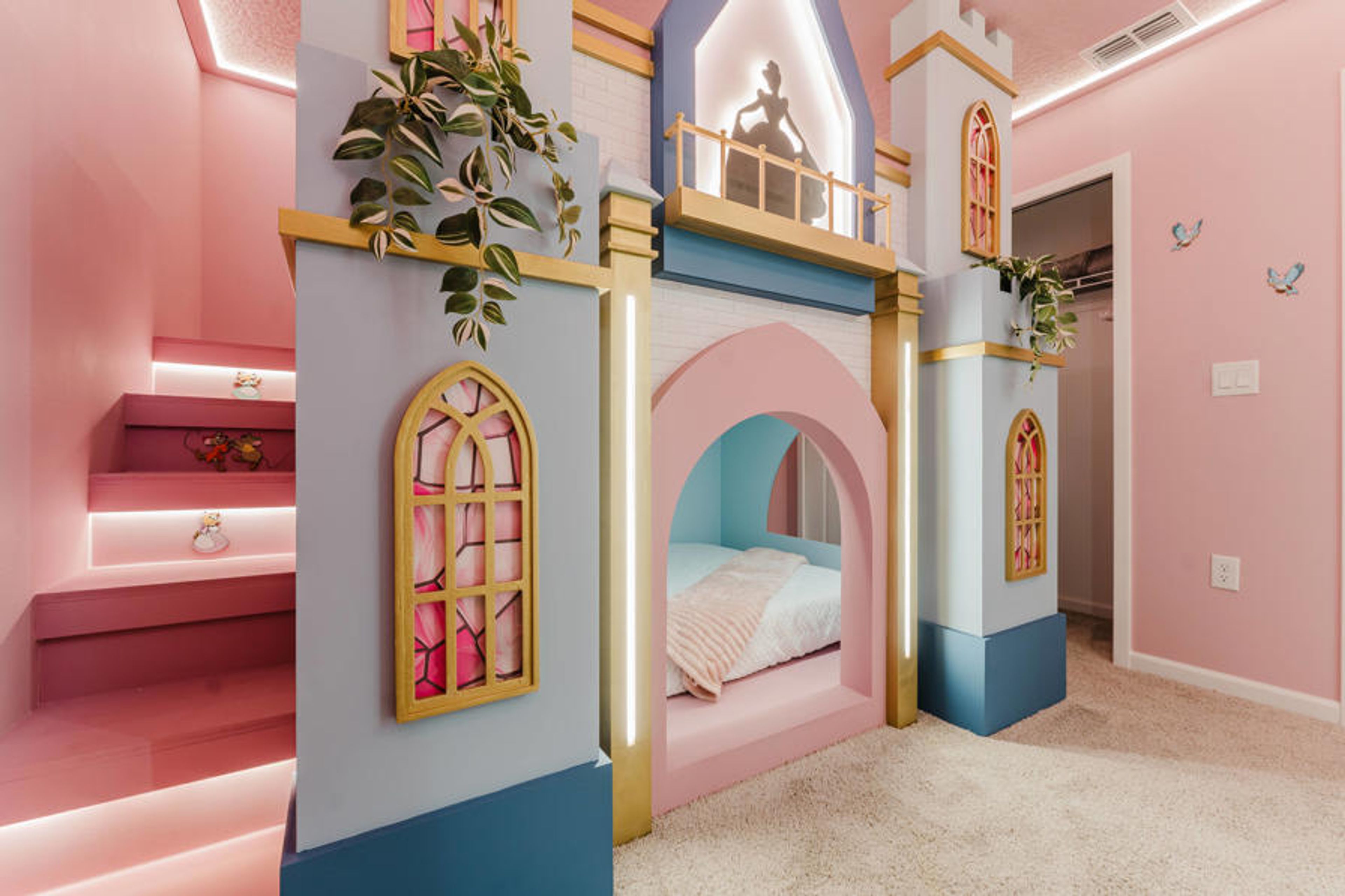 Enter a whimsical playroom with a charming castle-inspired structure in vibrant pinks and soft pastels. This cozy nook invites imaginative adventures, while gentle lighting creates a delightful, playful atmosphere for all.