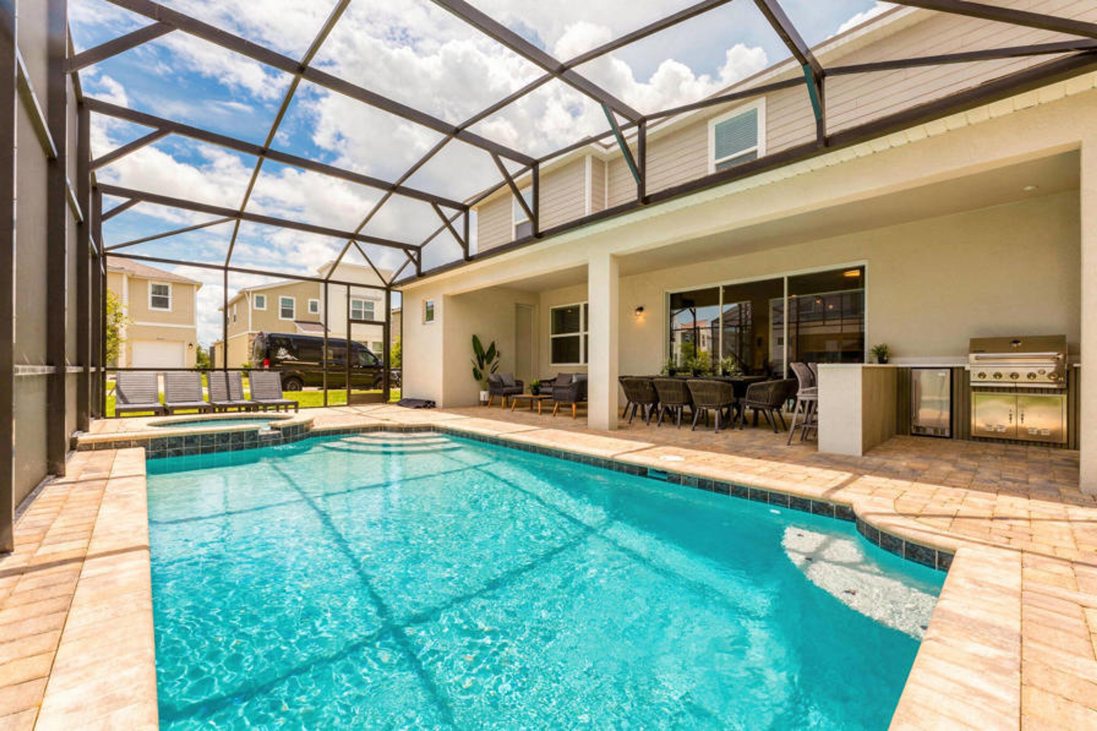 Step outside to your private oasis with a sparkling pool in a sleek screened enclosure. Enjoy the stylish outdoor seating area for relaxation, and take advantage of the nearby grill for delightful al fresco meals in the sun.