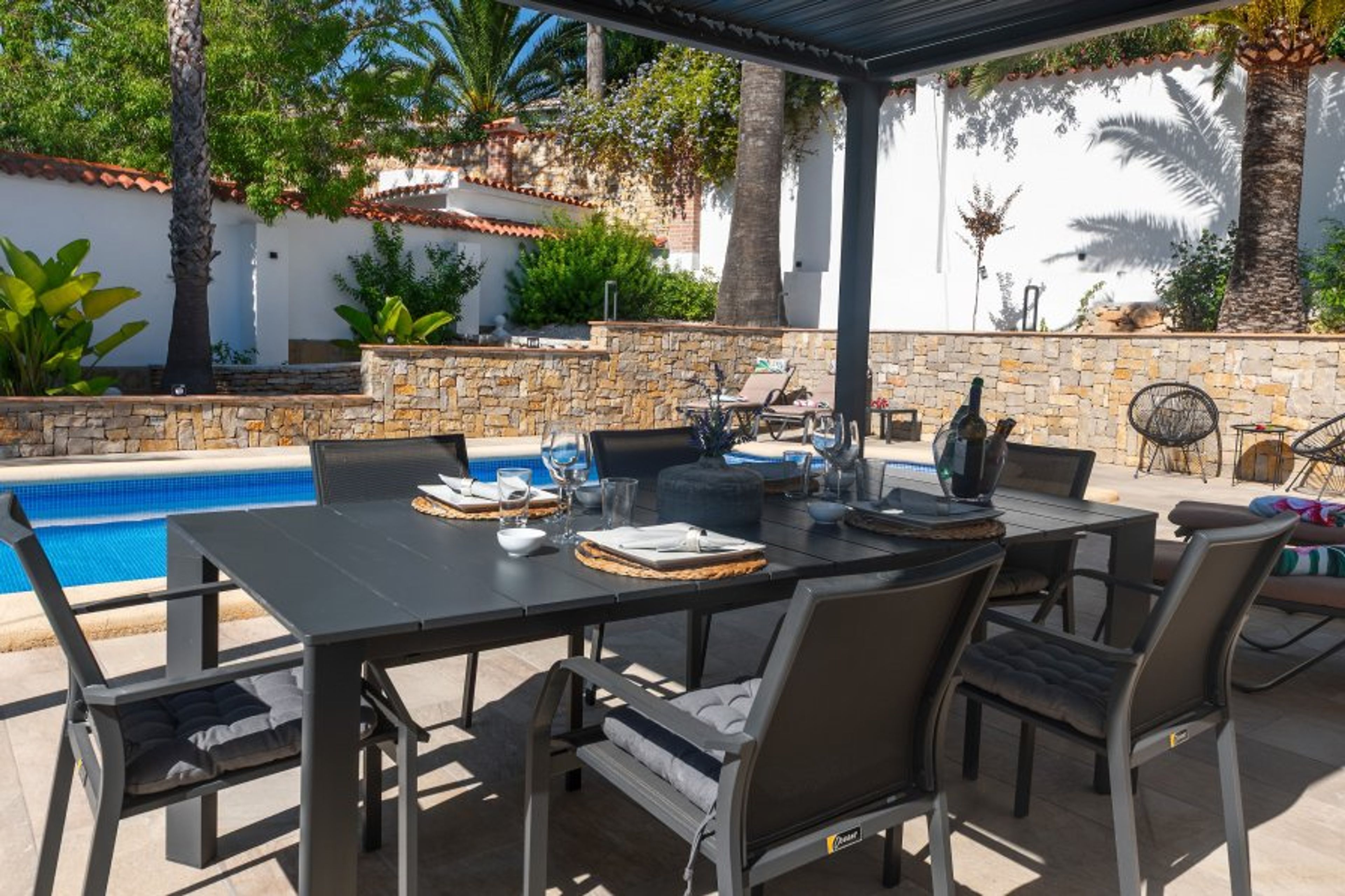 Covered dining area next to private pool