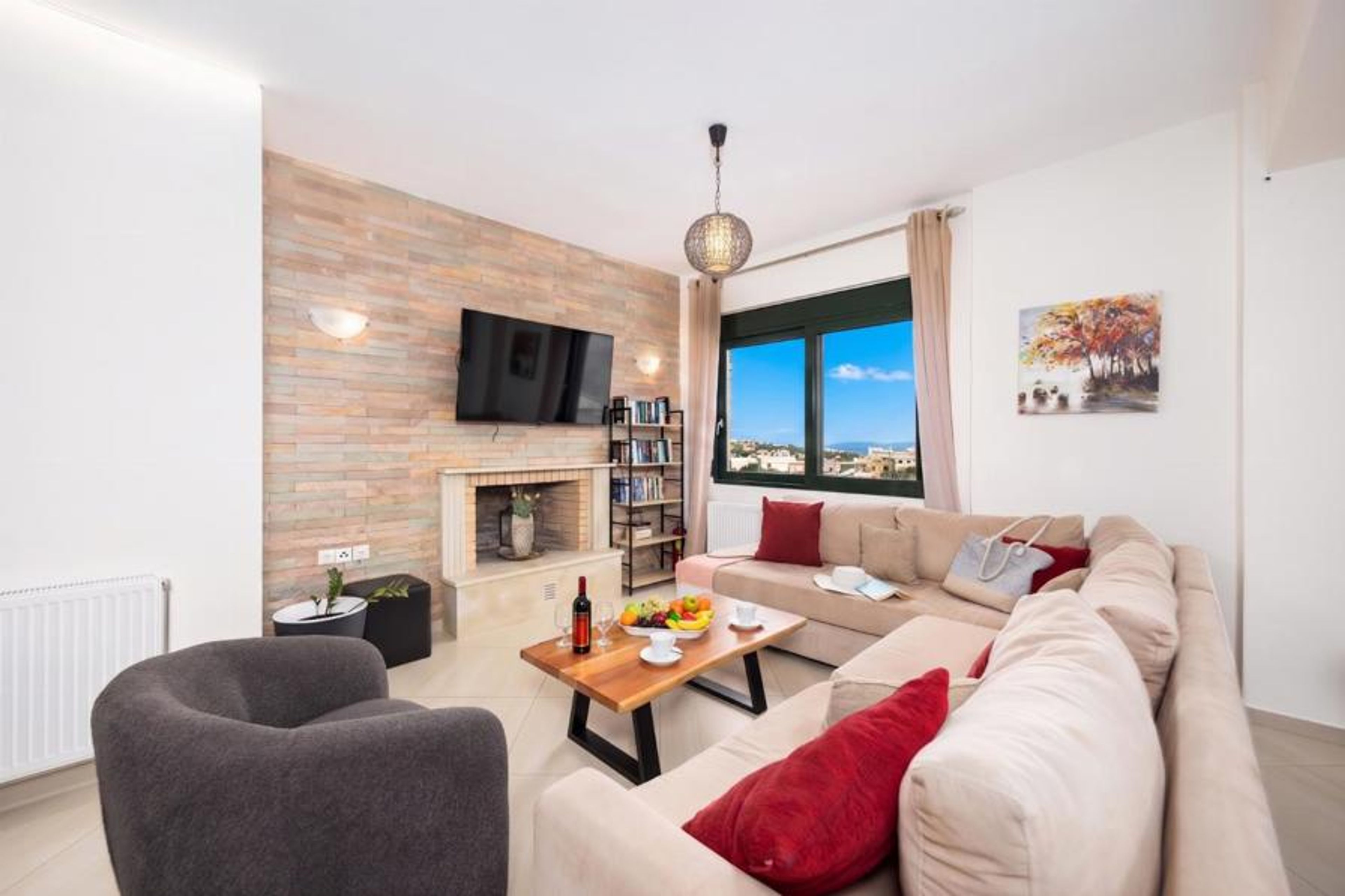 Open-plan living room with sofa, dining area, kitchen, ornamental fireplace, WiFi internet, and satellite TV