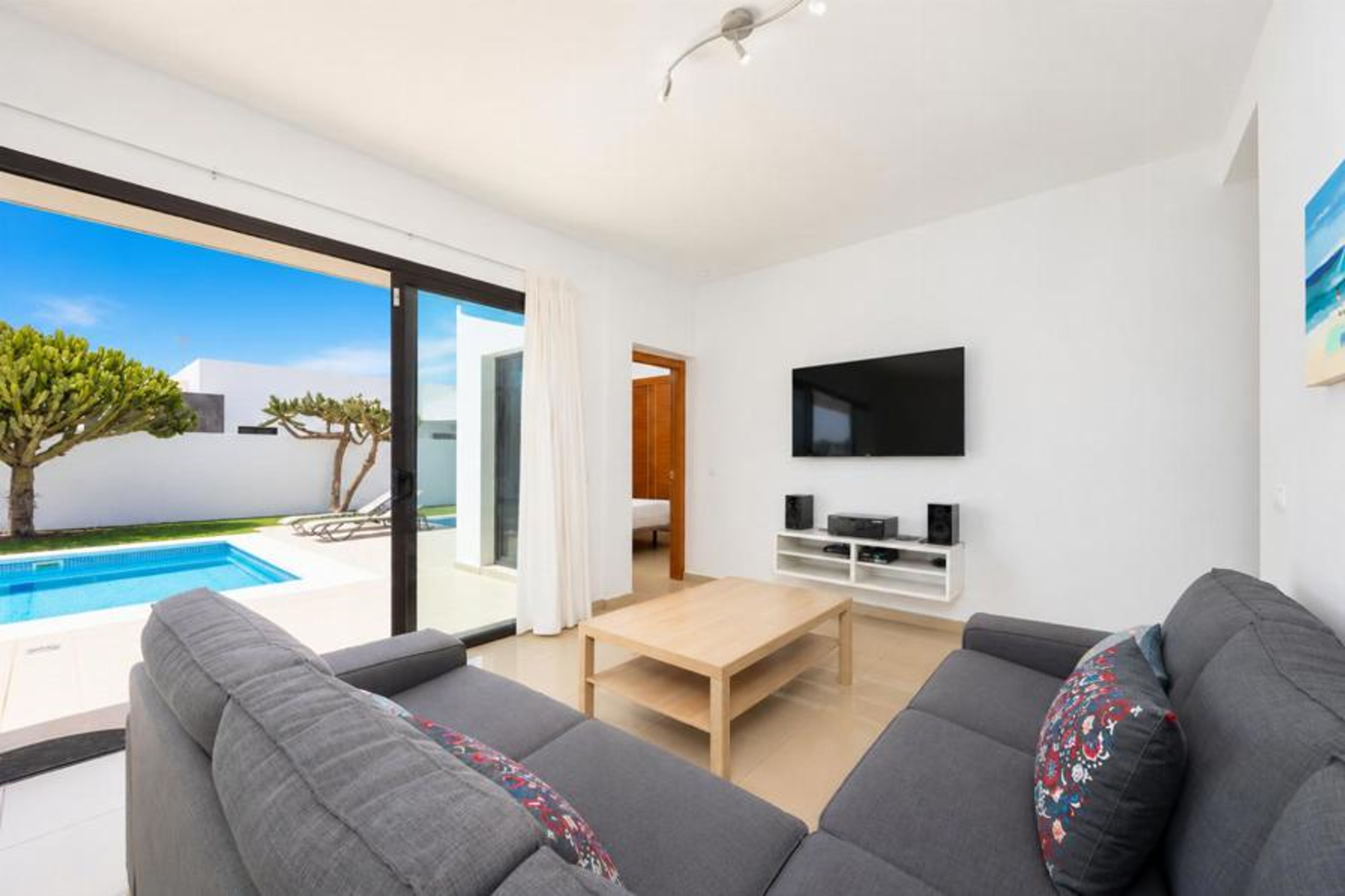 Living room with sofa, dining area, WiFi internet, and satellite TV