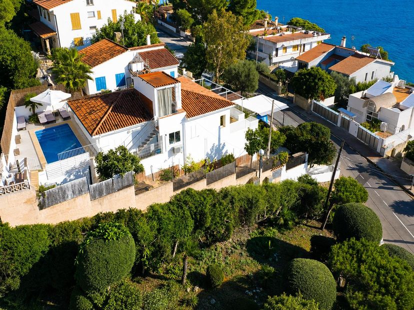 Villa in Spain, Alcanada: An aerial view showcases a multi-level white villa with traditional terr..