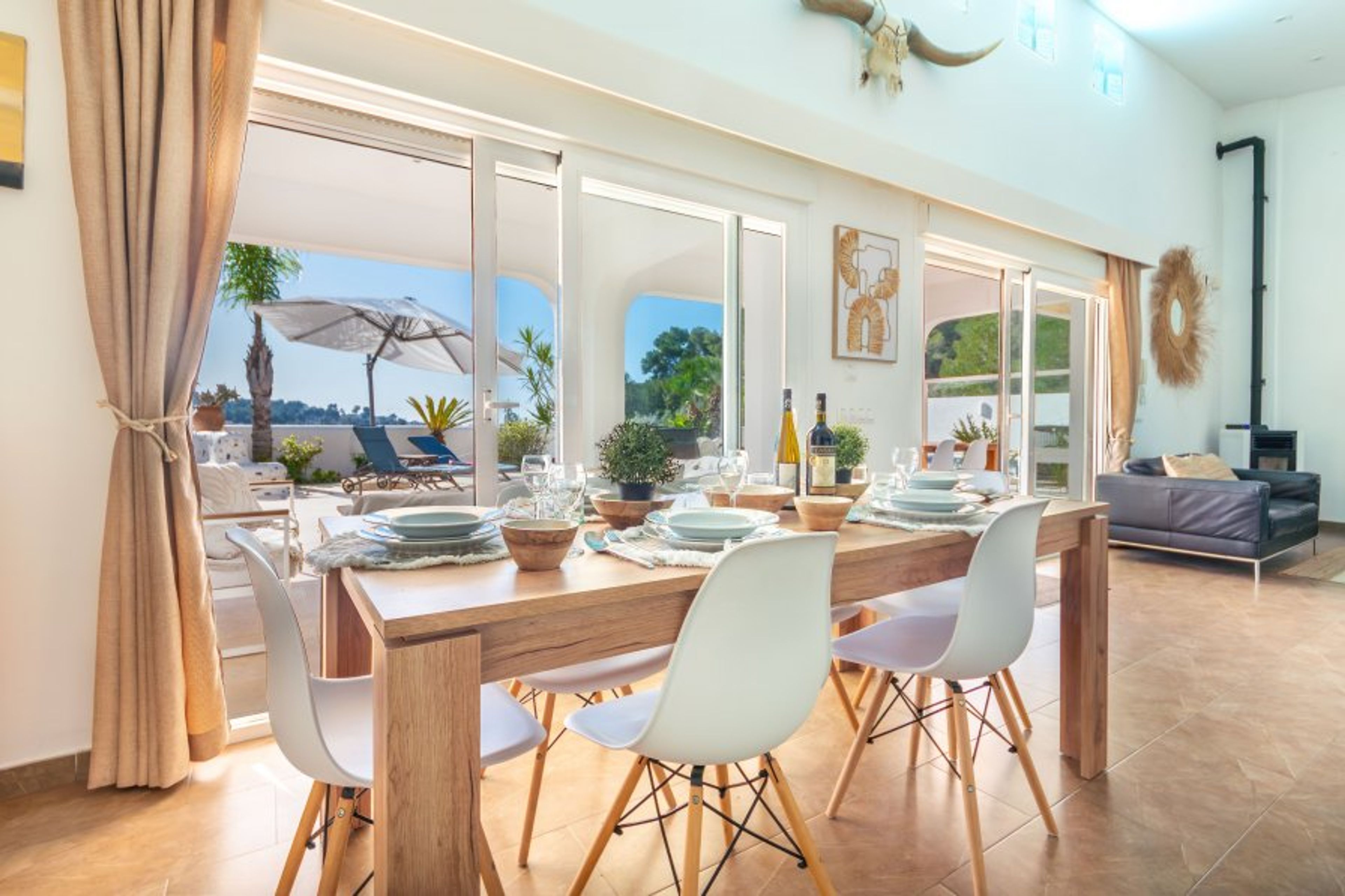 Sunny dining area with views and exit to the terrace and the pool