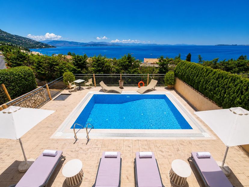 Villa in Greece, Barbati: Private pool terrace with sun loungers, umbrellas, and breathtaking pano..