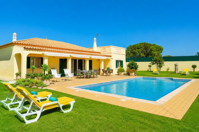 Villa in Portugal, Vilamoura: A ground-level view of a single-story villa featuring a rectangular ..